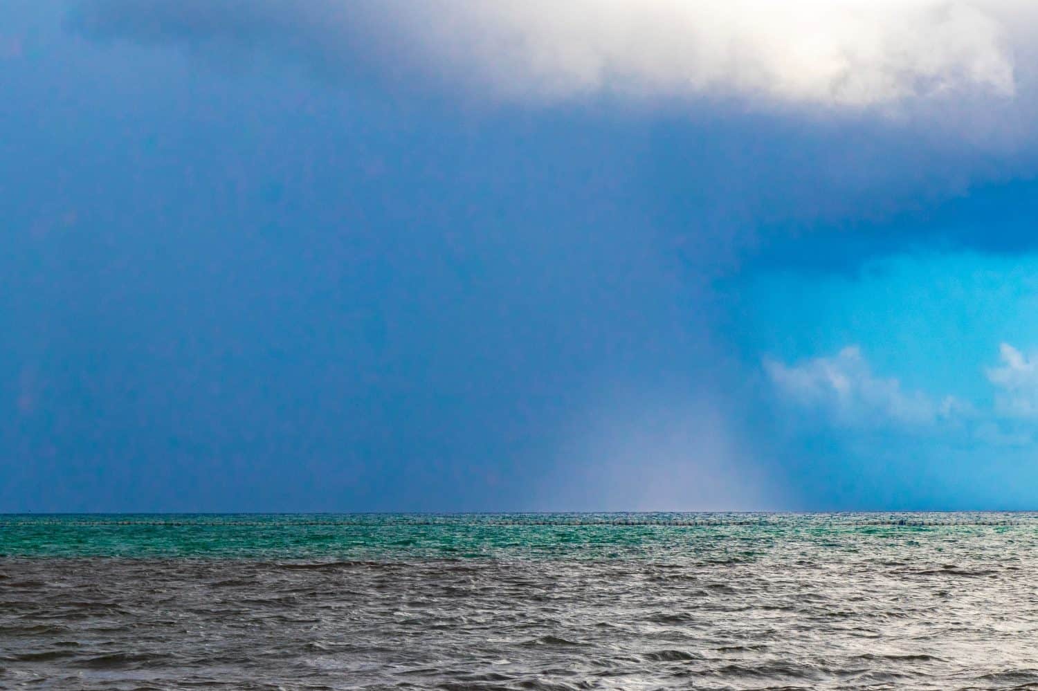 Thunderstorm strong monsoon rain hurricane gloomy clouds in paradise in Playa del Carmen Mexico.