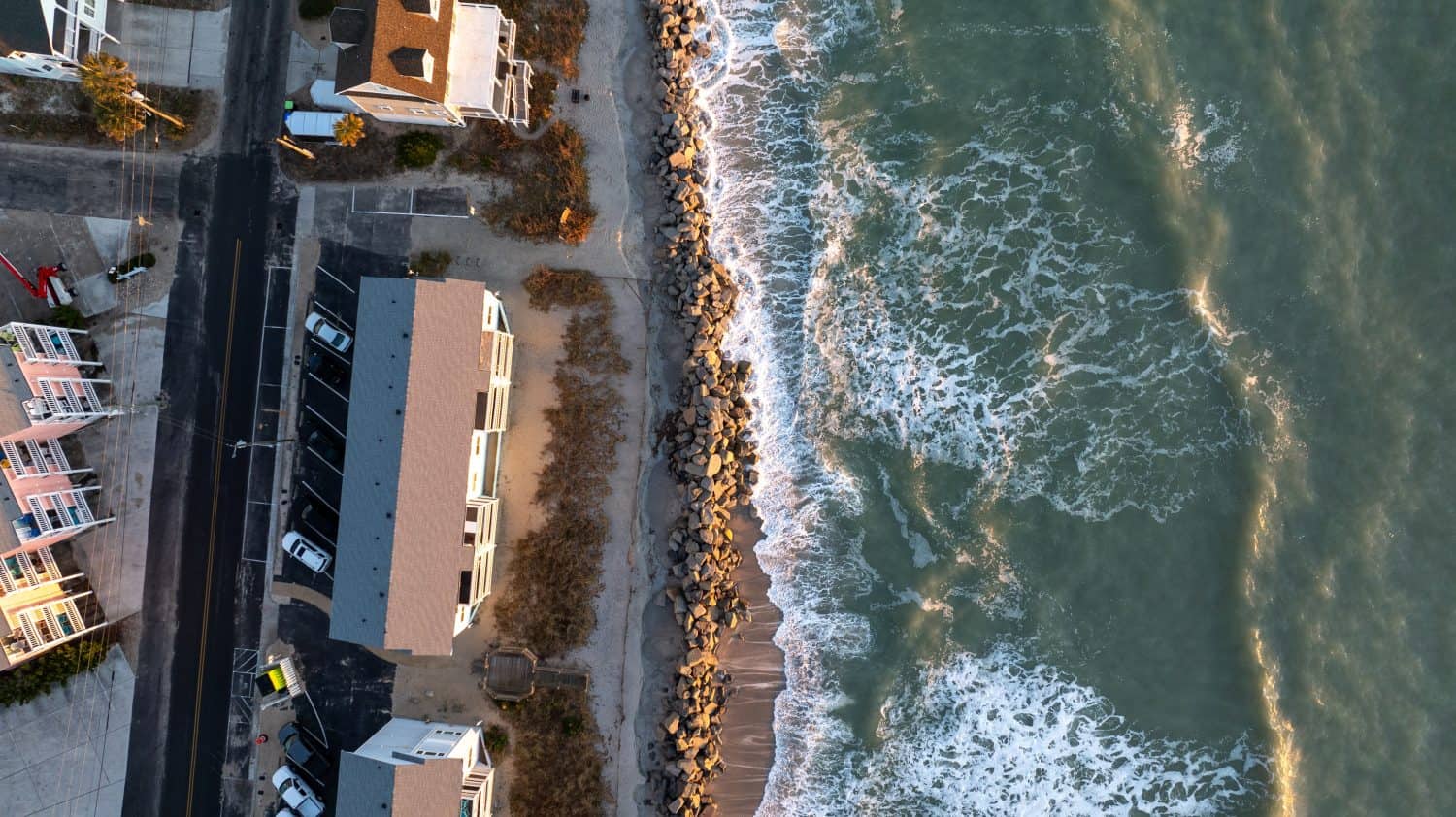 Coastal homes in Carolina Beach, NC face the Atlantic, highlighting the risks of climate change and the importance of flood insurance.