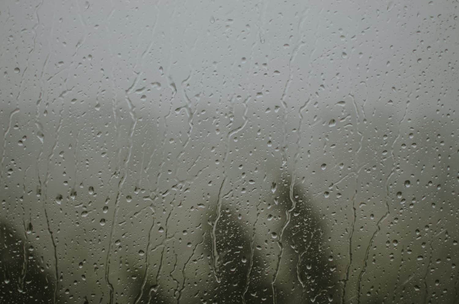 raindrops on the window during a strong hurricane with wind in nature