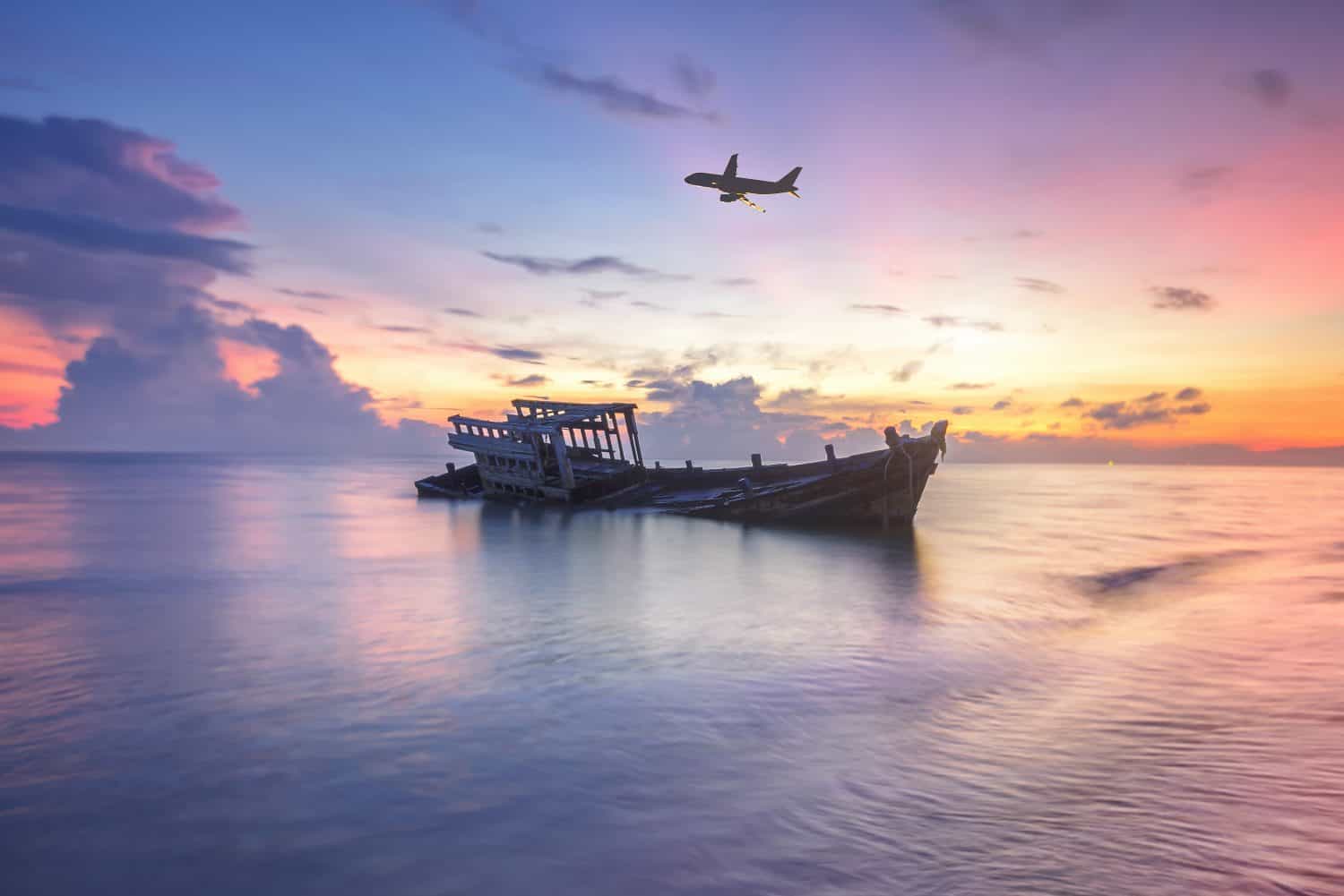 Wreck fishing boat next to the beach, Thailand U-Tapao Airport. Wrecked boat abandoned stand on beach or Shipwrecked off the coast of Thailand.