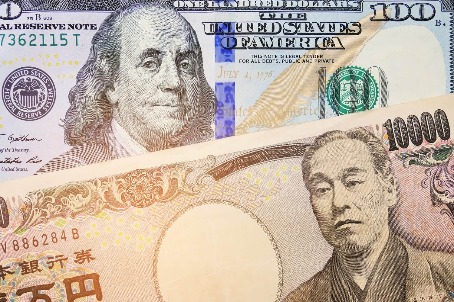 Japanese Yen and USD Dollar Bank note pile, Business and finance concept. 10,000 Japanese Yen and 100 dollar BankNote. Money background.currency exchange rate