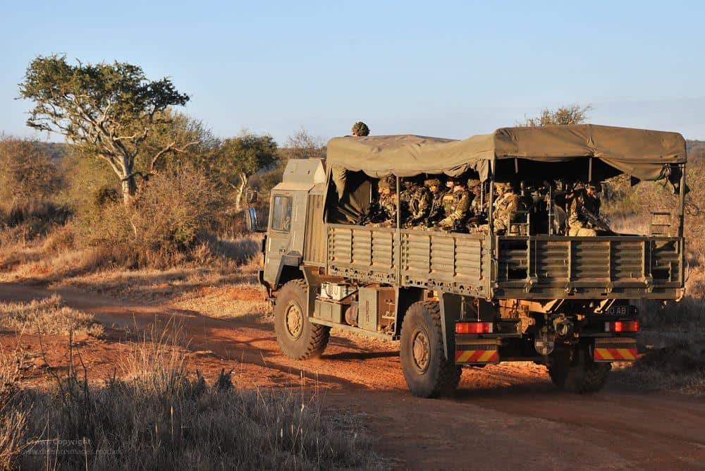 Soldiers on a Troop Carrying Vehicle in Kenya by Defence Images