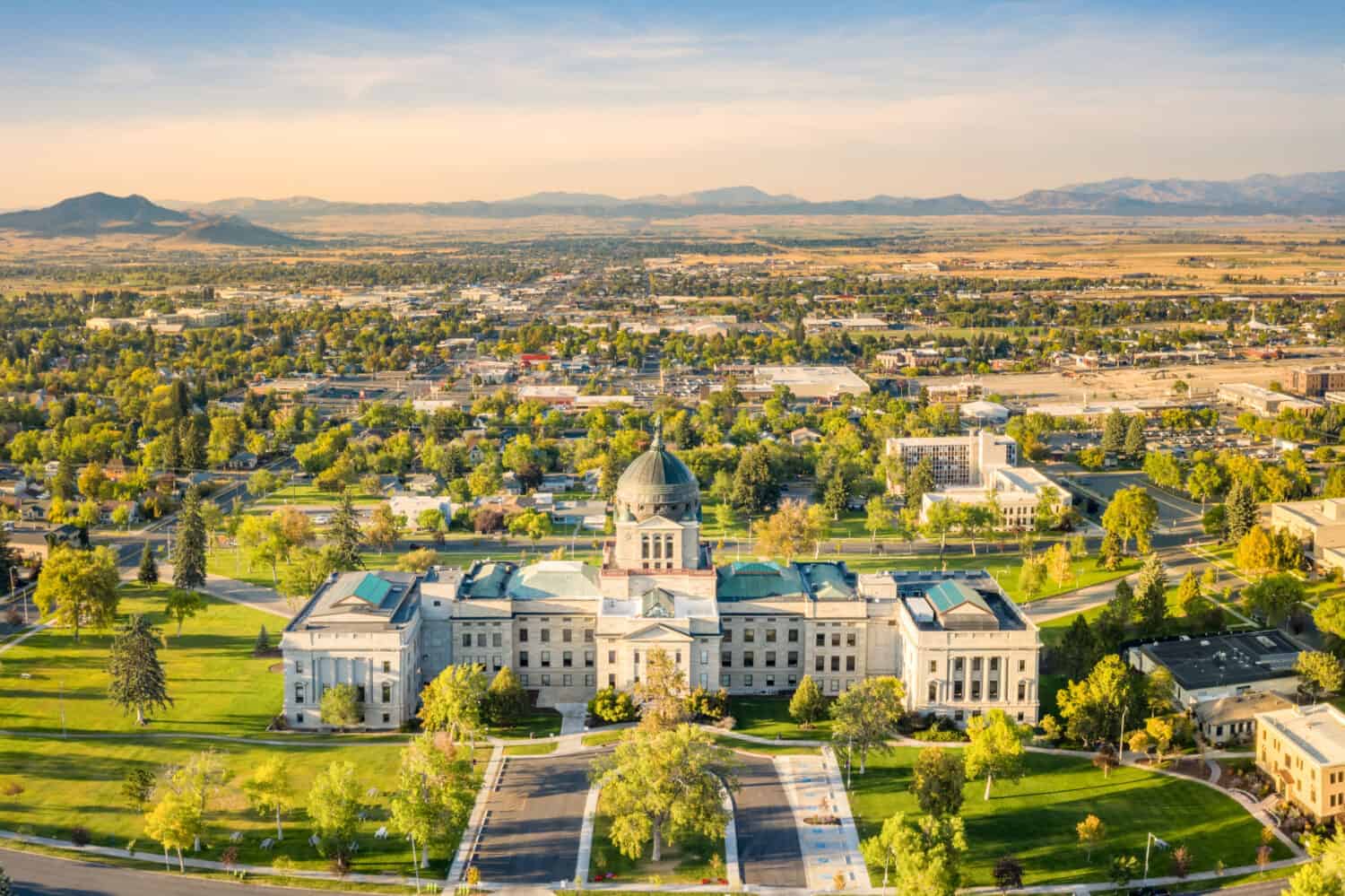 Drone view of the Montana State Capitol, in Helena, on a sunny afternoon with hazy sky caused by wildfires. The Montana State Capitol houses the Montana State Legislature.