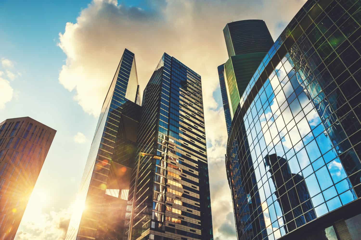 Modern glass skyscrapers against the sky at sunset. Bottom up view. Moscow, Russia