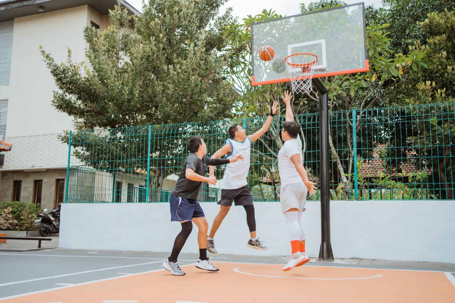 basketball player jumping with rebound position while playing