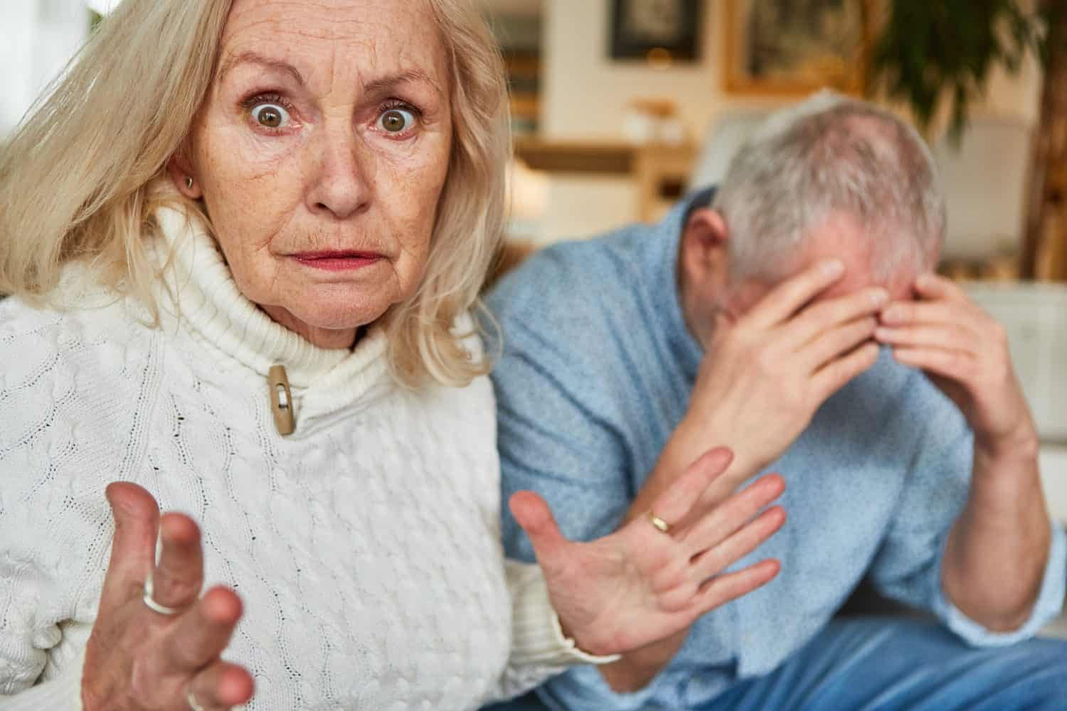 Elderly woman angry quarreling with sad senior for relationship conflict and aggression