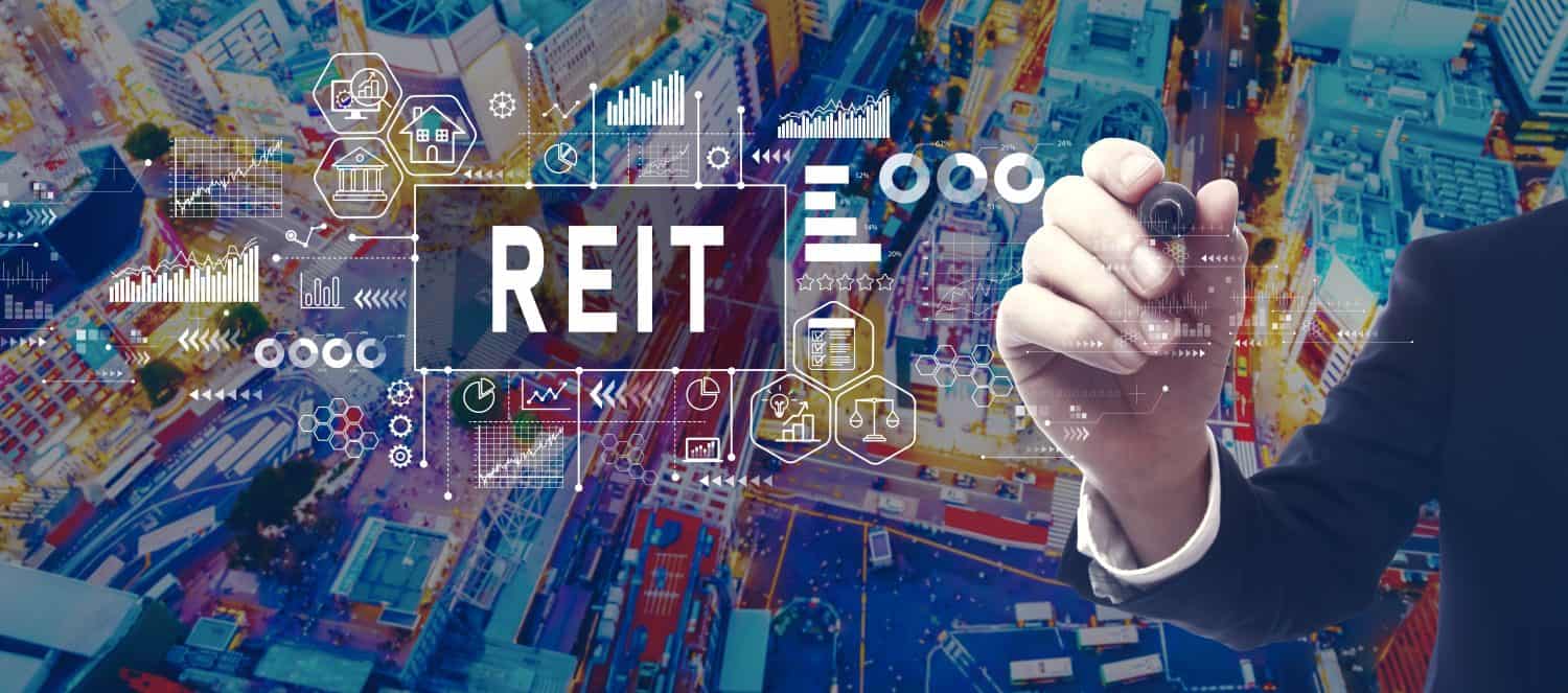 REIT - Real Estate Investment Trust theme with businessman in a city at night