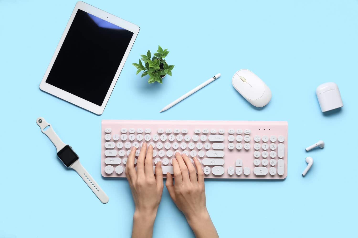 Female hands with different gadgets on color background