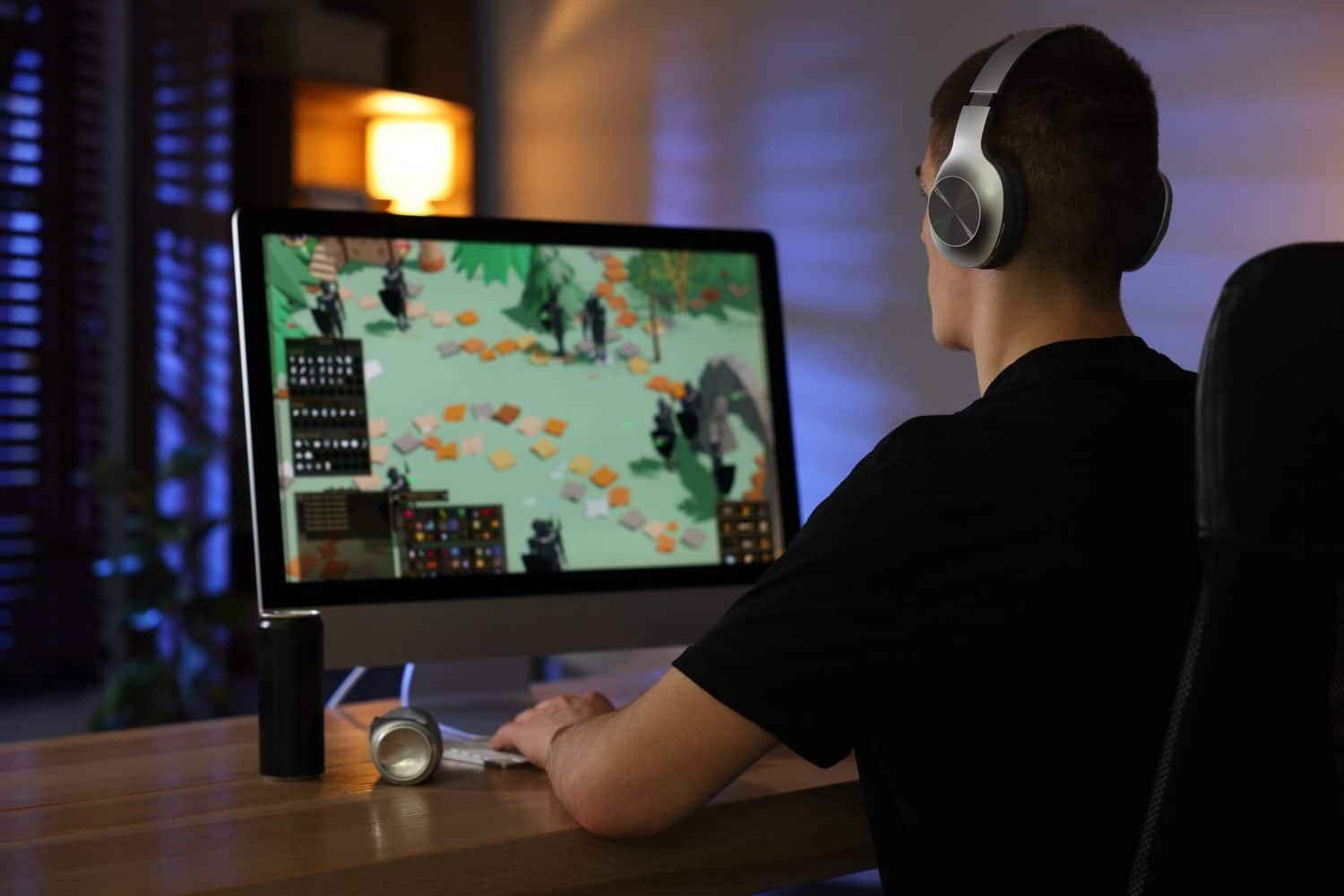 Man playing video games on computer at table indoors