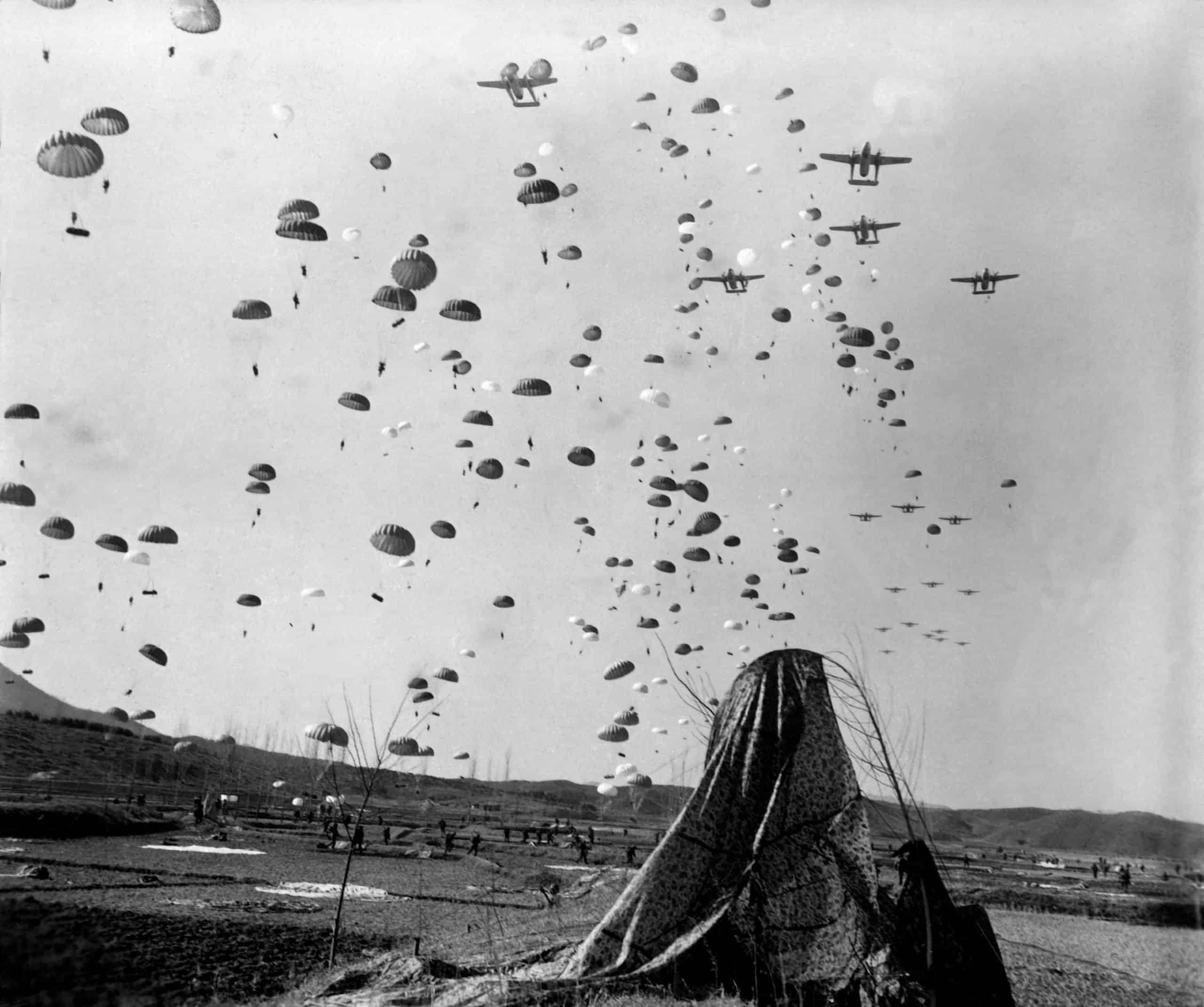 Paratroopers jump from from C-119's over Korea.