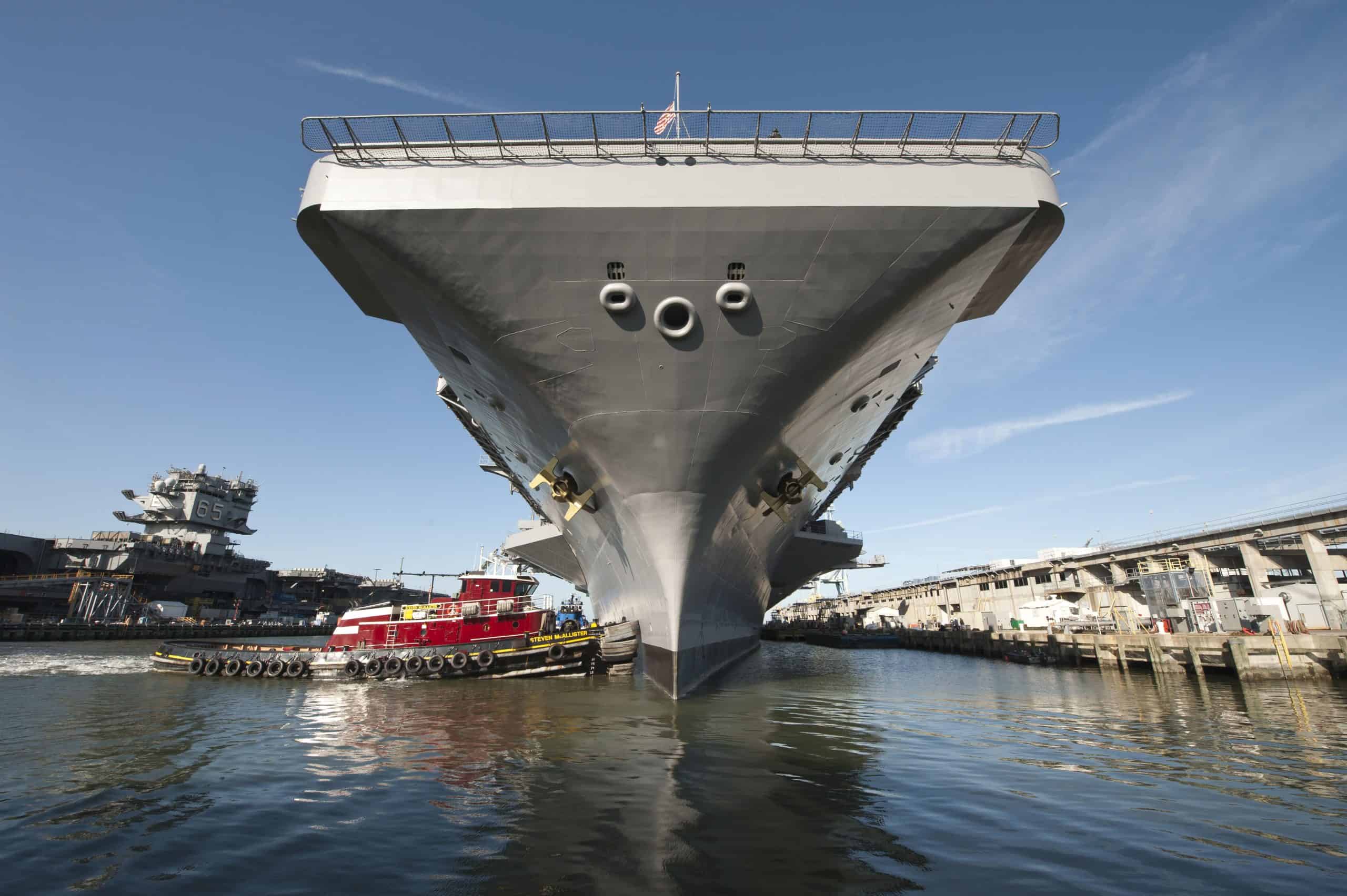 Newport News, Virginia, August 25, 2013 - The aircraft carrier USS Theodore Roosevelt (CVN-71) pulls out of Newport News Shipyard.