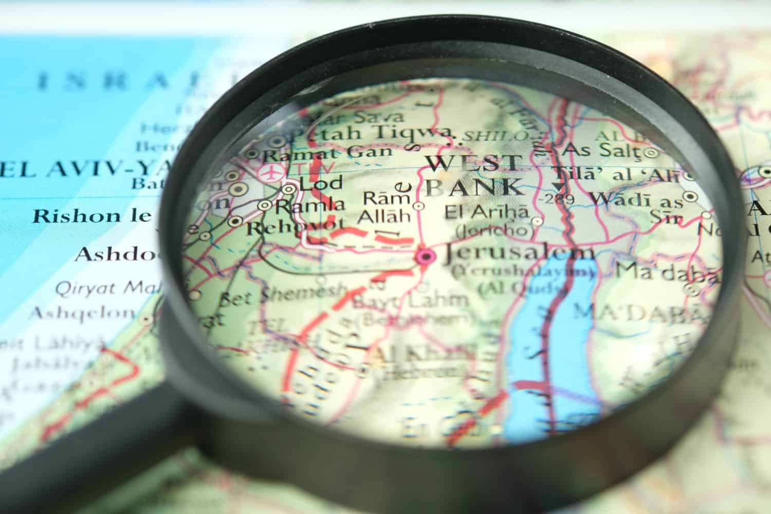 Close up of West Bank under a magnifying glass on a map