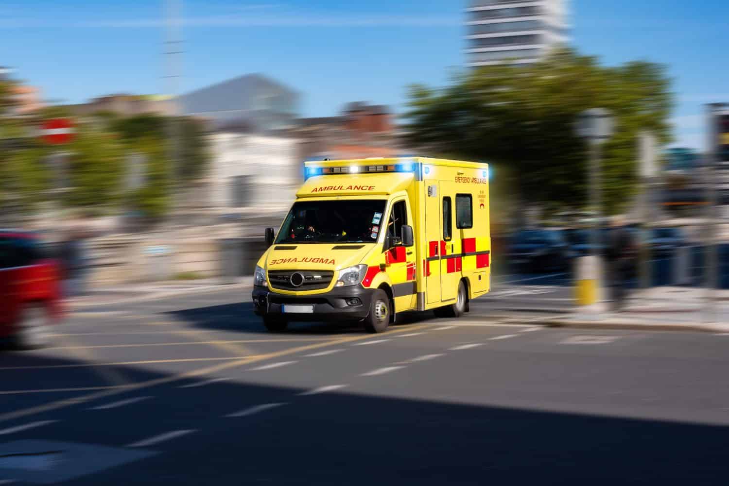 Ambulance responding to emergency call driving fast on street