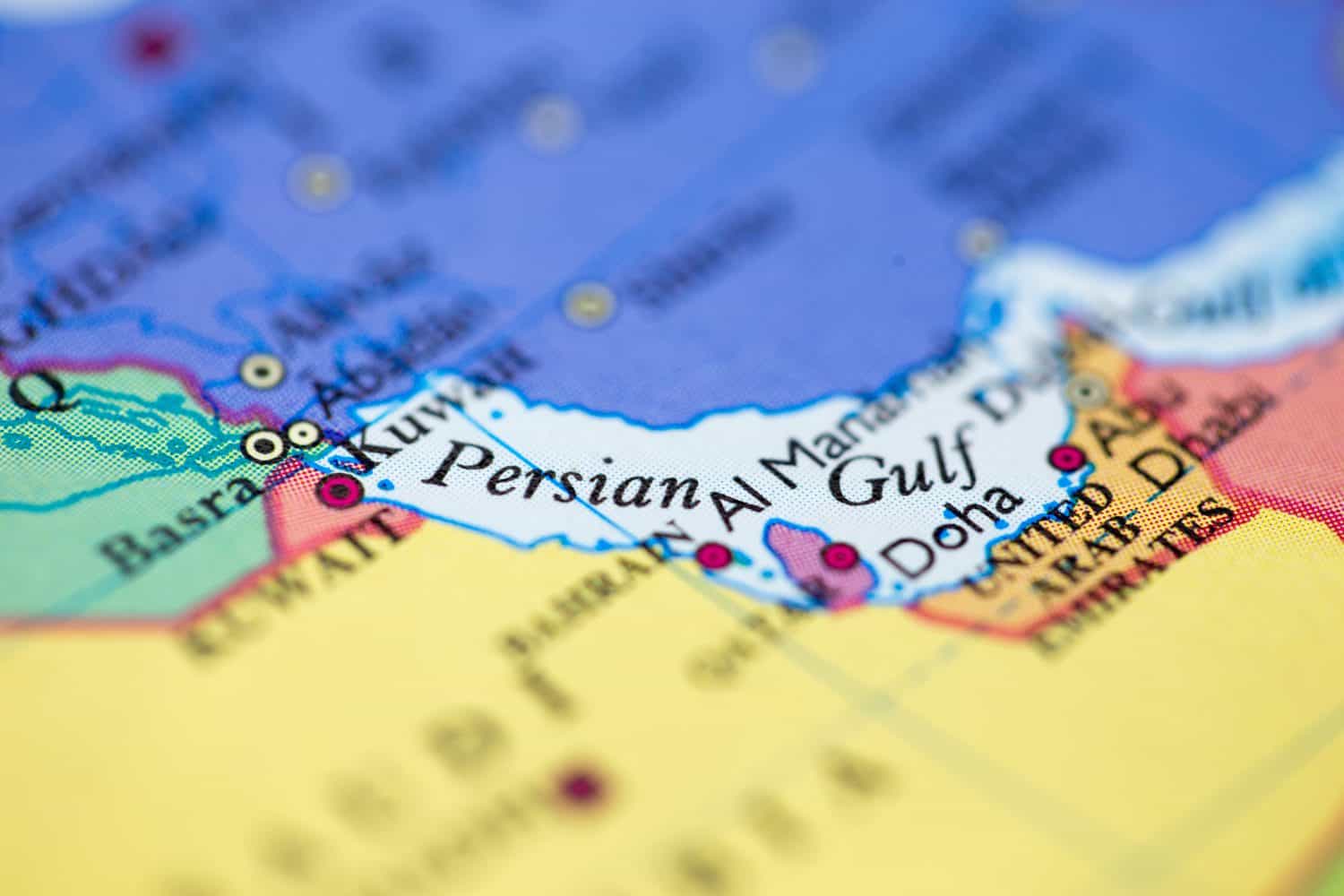 Shallow depth of field focus on geographical map location of Persian Gulf off coast of Saudi Arabia on atlas