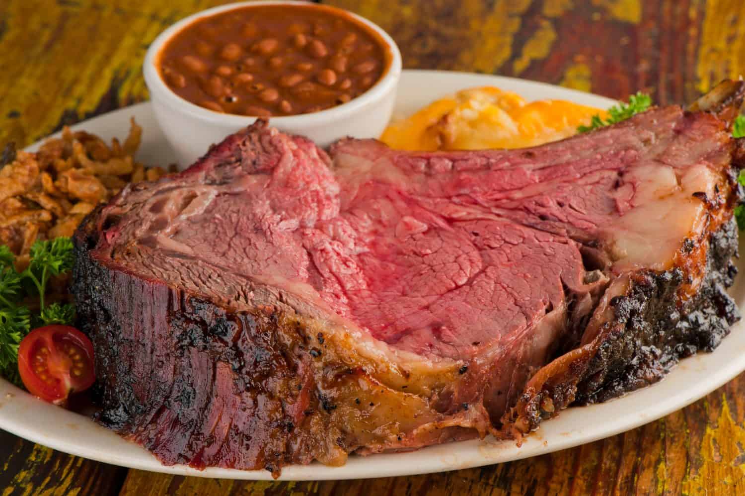 Prime Rib. Beef Prime Rib bbq. Beef rubbed in spices and seasoning and slow cooked in a smoke house with mesquite wood chips. Traditional barbecue Texas Smoke House beef prime rib.