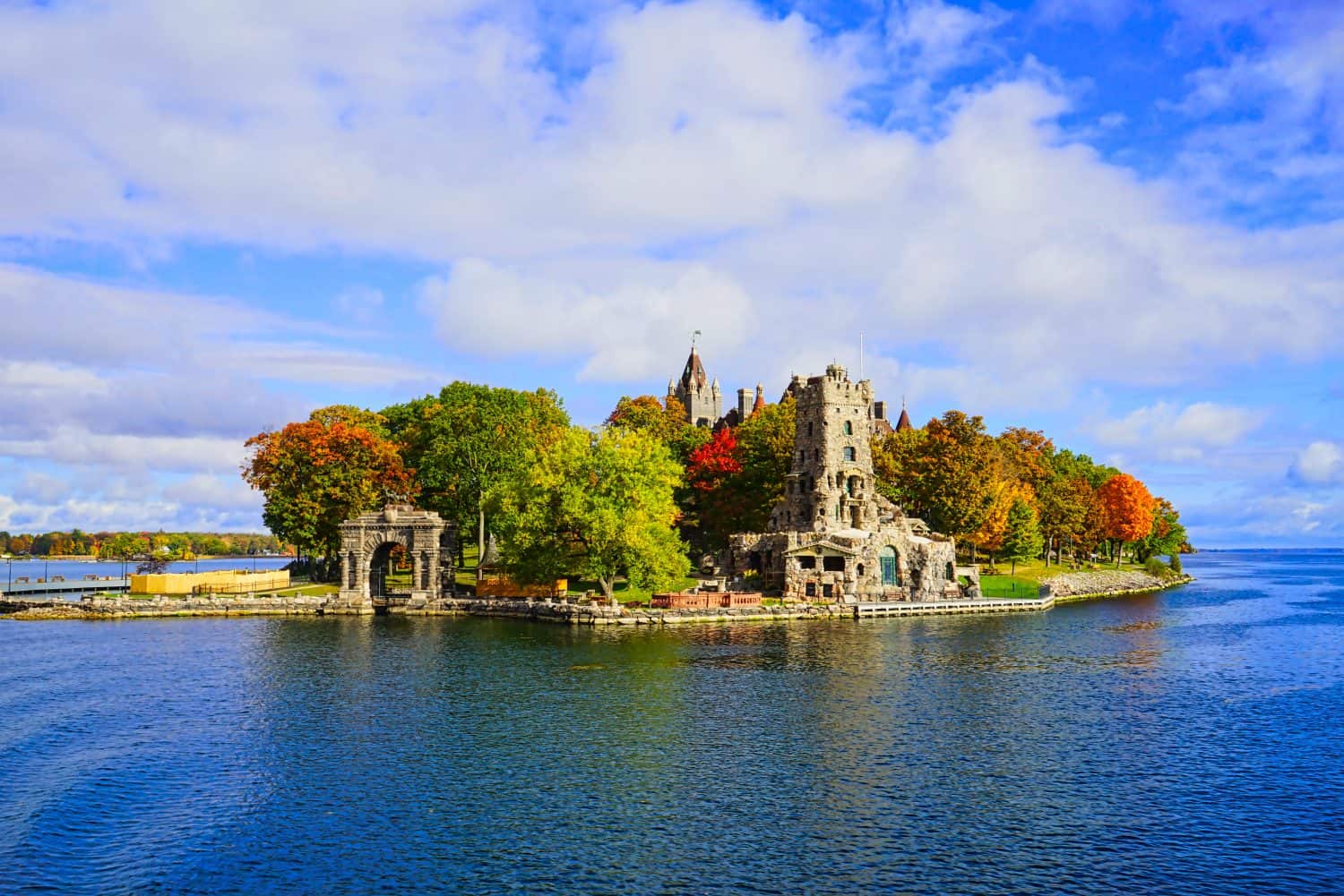 Historic Boldt Castle on Heart Island. Tree, leaves, river, blue sky.Autumn in the Thousand Islands at the St. Lawrence River. New York State, 2016.