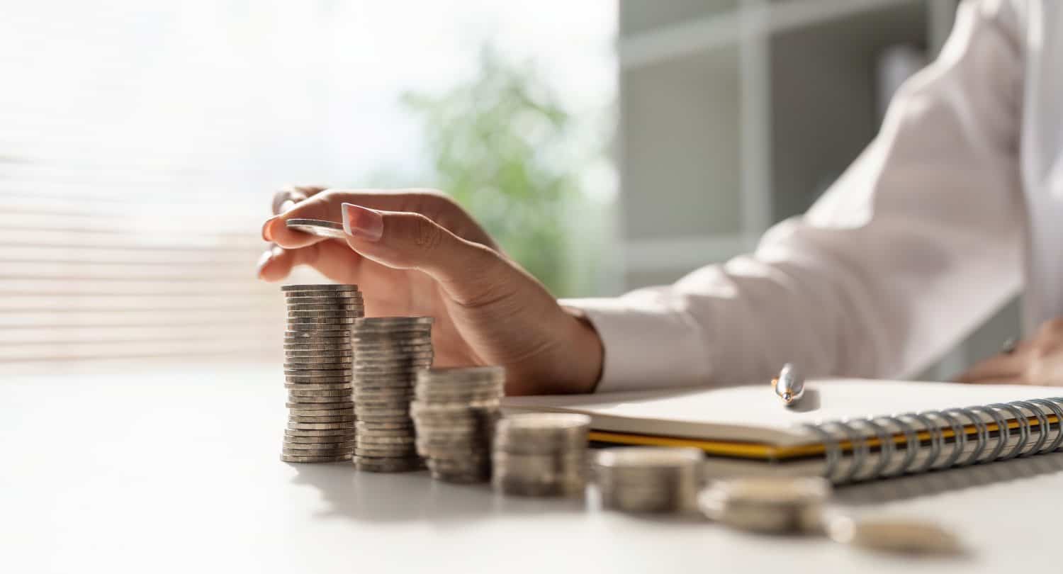 Young Asian woman making stack of coin. invest save finance concept, saving money, investment