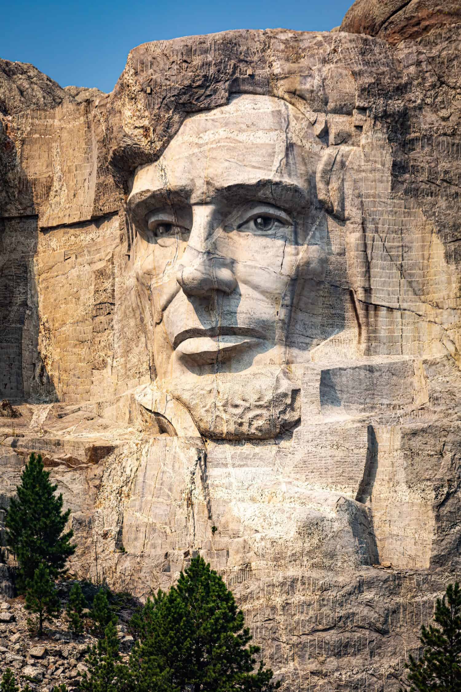 Portrait of Abraham Lincoln on Mount Rushmore. Mount Rushmore National Memorial is centered on a colossal sculpture carved into the granite in the Black Hills in Keystone, South Dakota