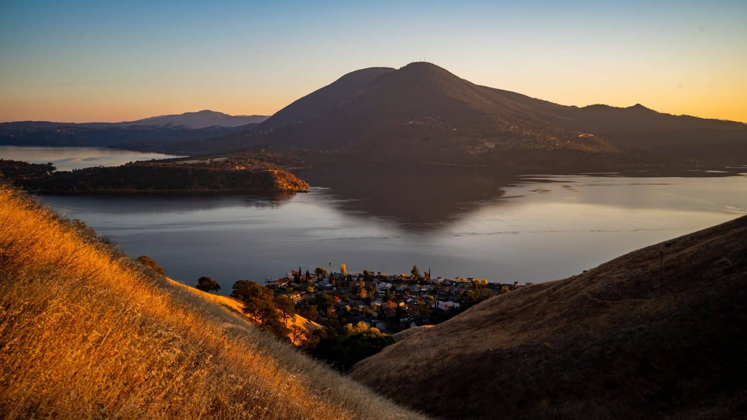 Panoramic view of Mount Konocti and Clear Lake landscape in Lake County, California during golden hour sunset