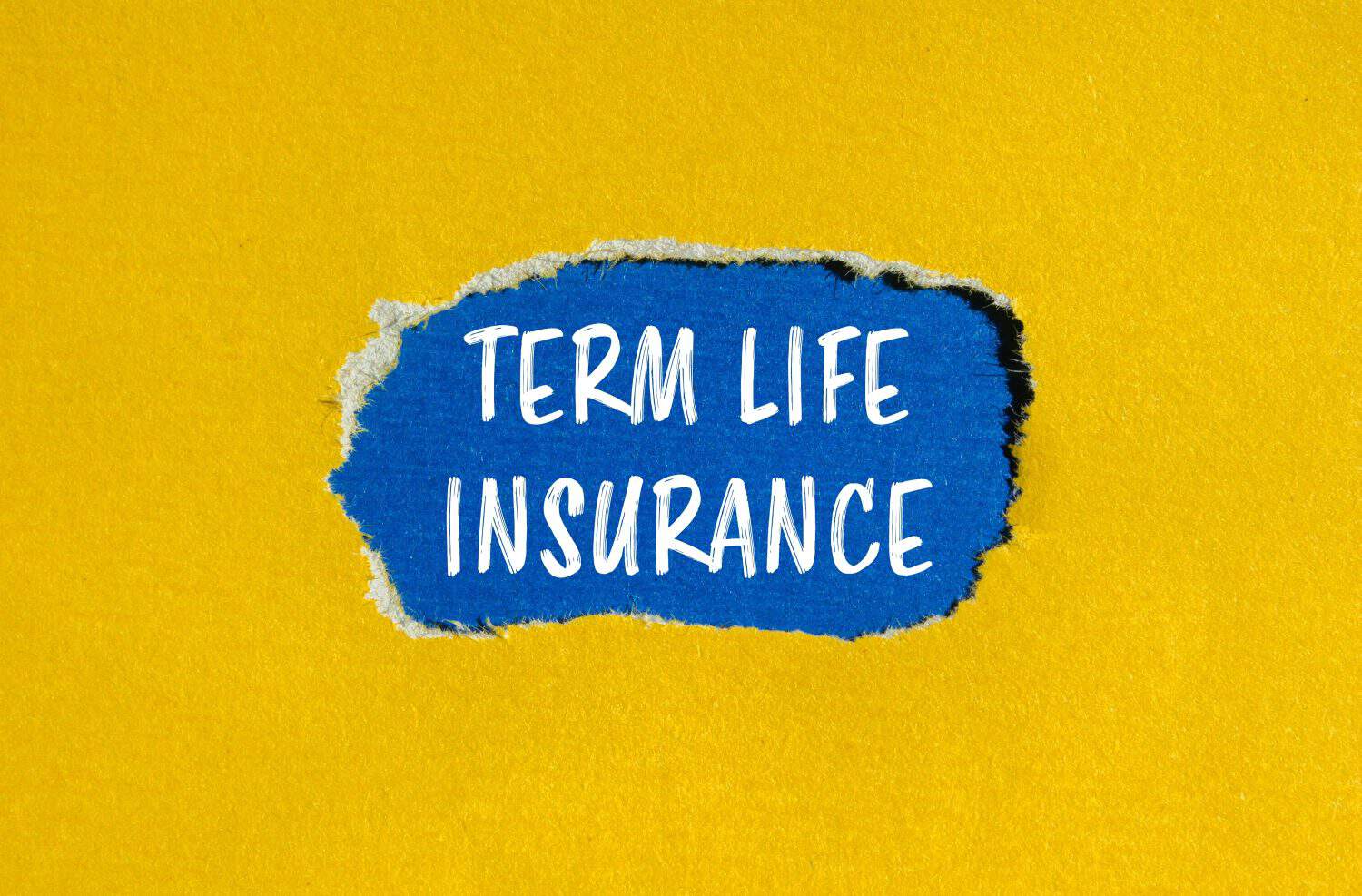 Term life insurance words written on ripped yellow paper with blue background. Conceptual term life insurance symbol. Copy space.