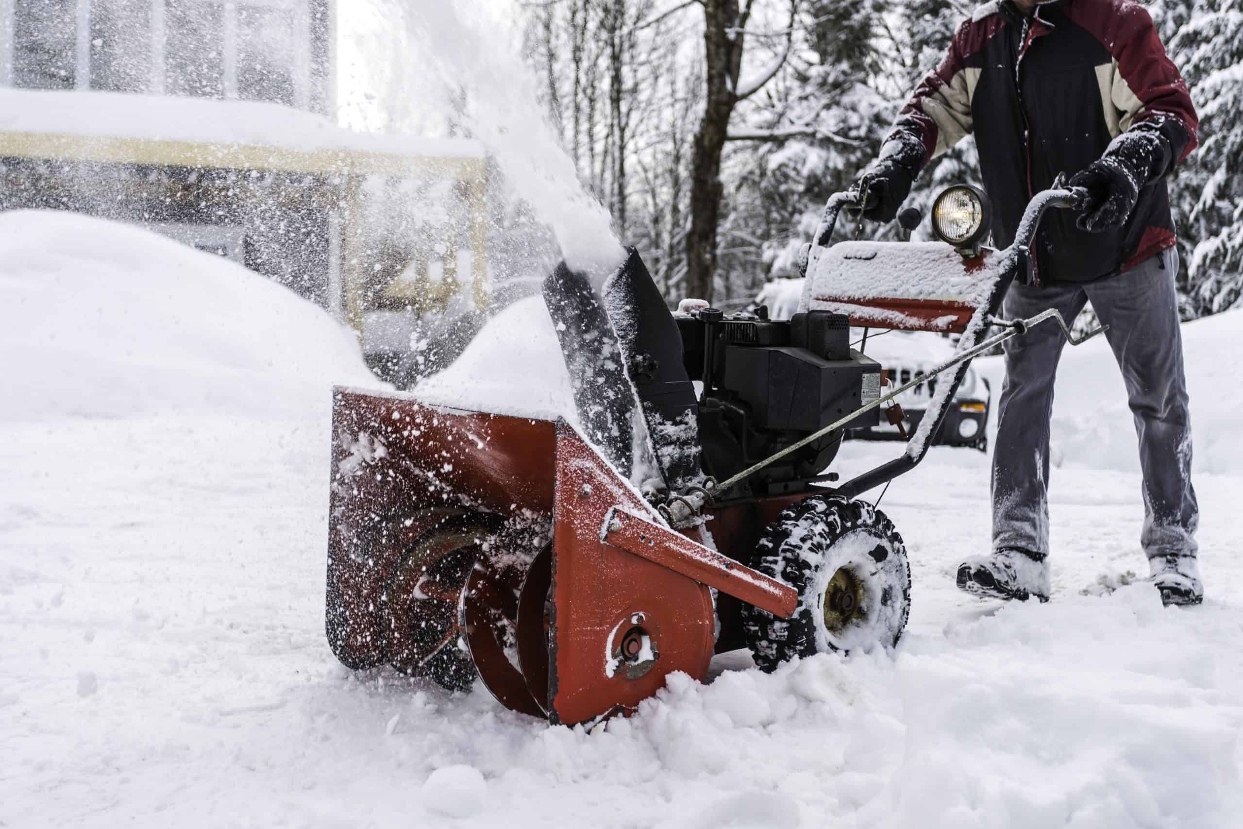 Senior Man Using SnowBlower After a Snowstorm