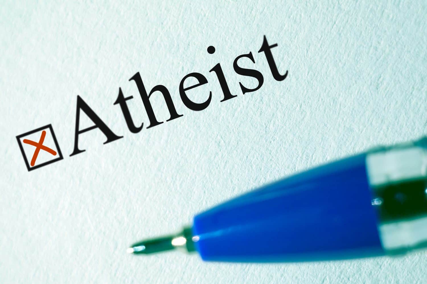 Atheist - checkbox with a cross, white paper with pen. Checklist concept