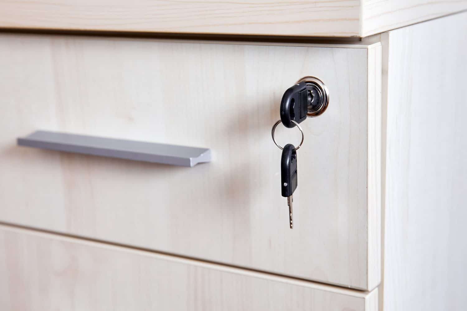 Key in office cabinet drawer lock with a spare key on the keyring