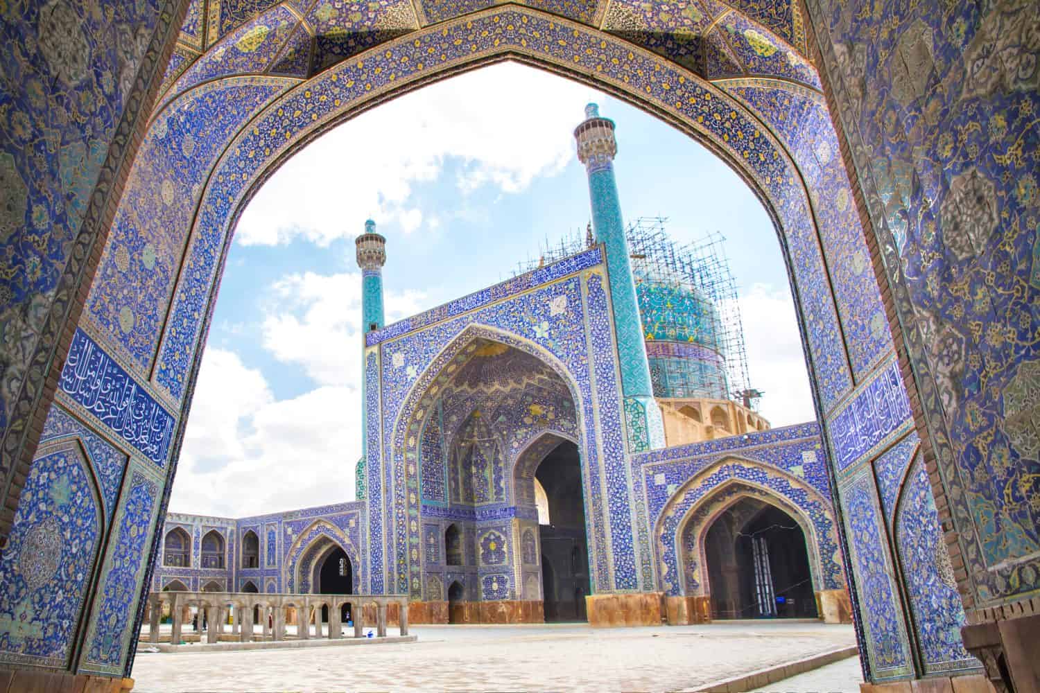 A public square at sunset and grand mosque with religious calligraphic scripts from Islamic Quran, Isfahan, UNESCO World Heritage site, Iran. Property release is not required for this public place.