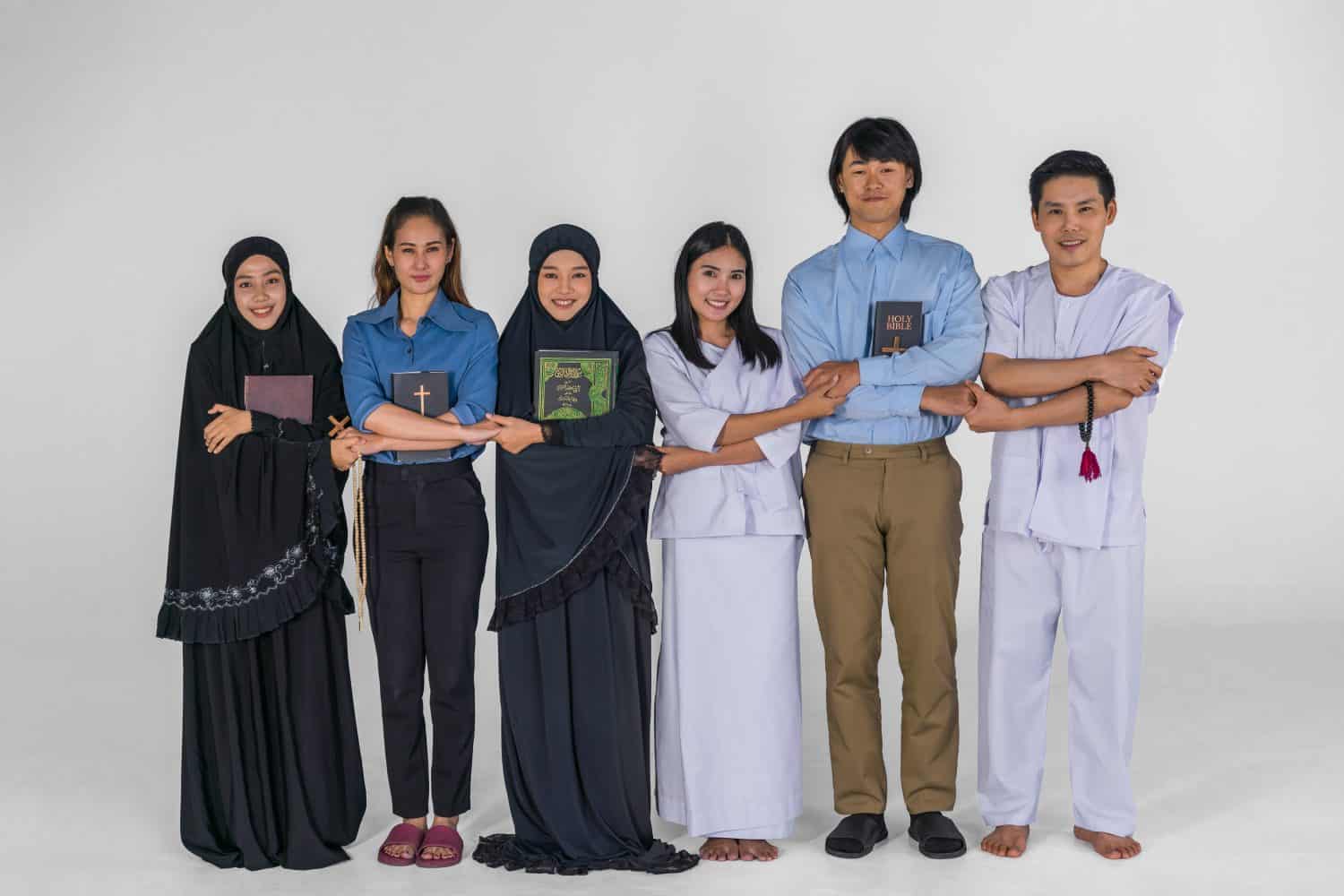 portrait of multicultural group of diverse religious asian people Christian Buddhist and muslim posing together showing inclusive teamwork and cooperation. arabic calligraphy mean the Noble Quran