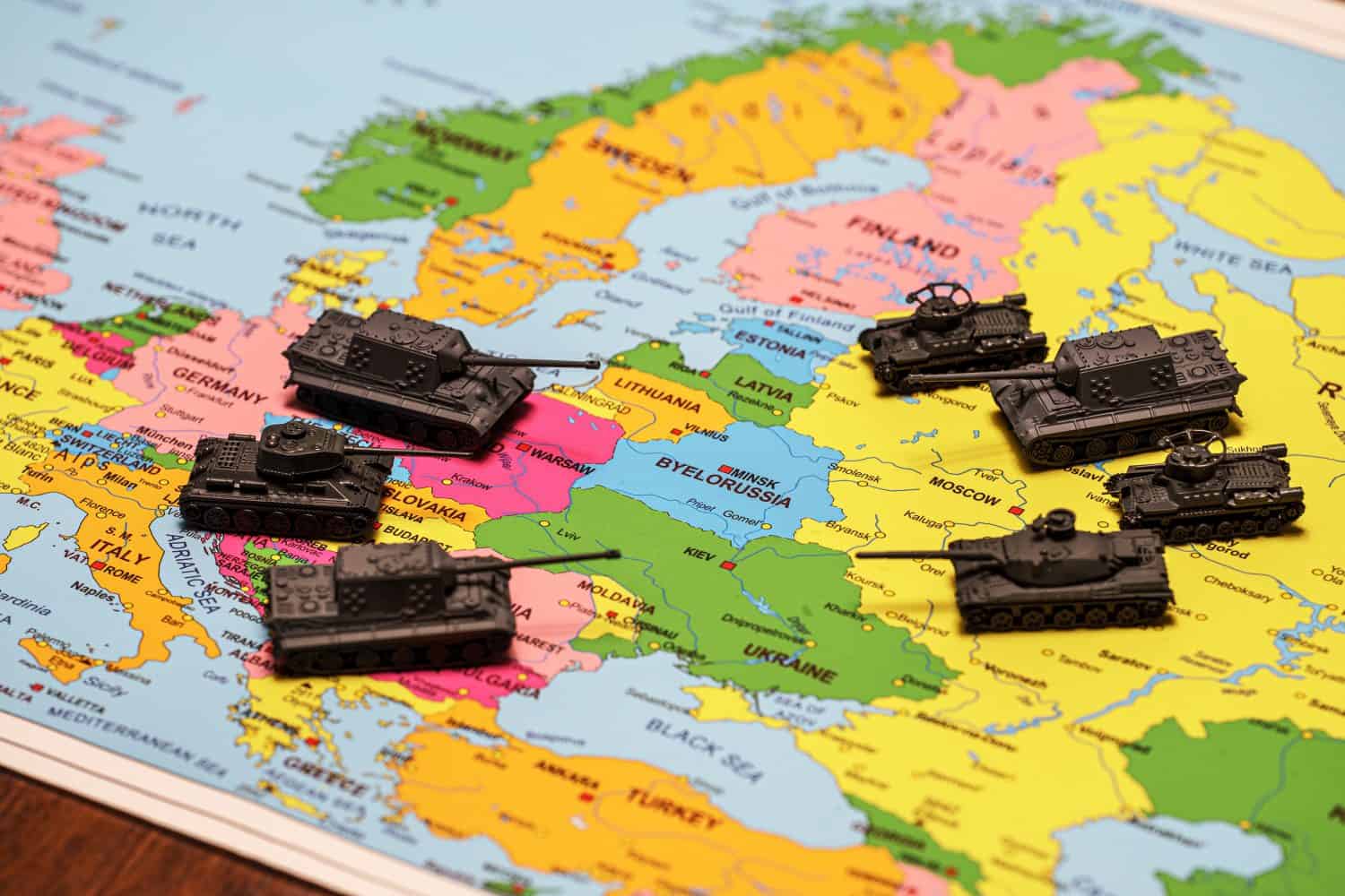 Toy tanks on the map. Concept of confrontation between NATO and Russia.