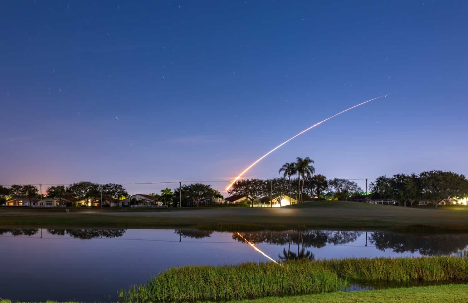 The launch of the Artemis 1 NASA rocket with trajektory reflected in the lake at Boynton Beach, Florida, USA by Elena_Suvorova