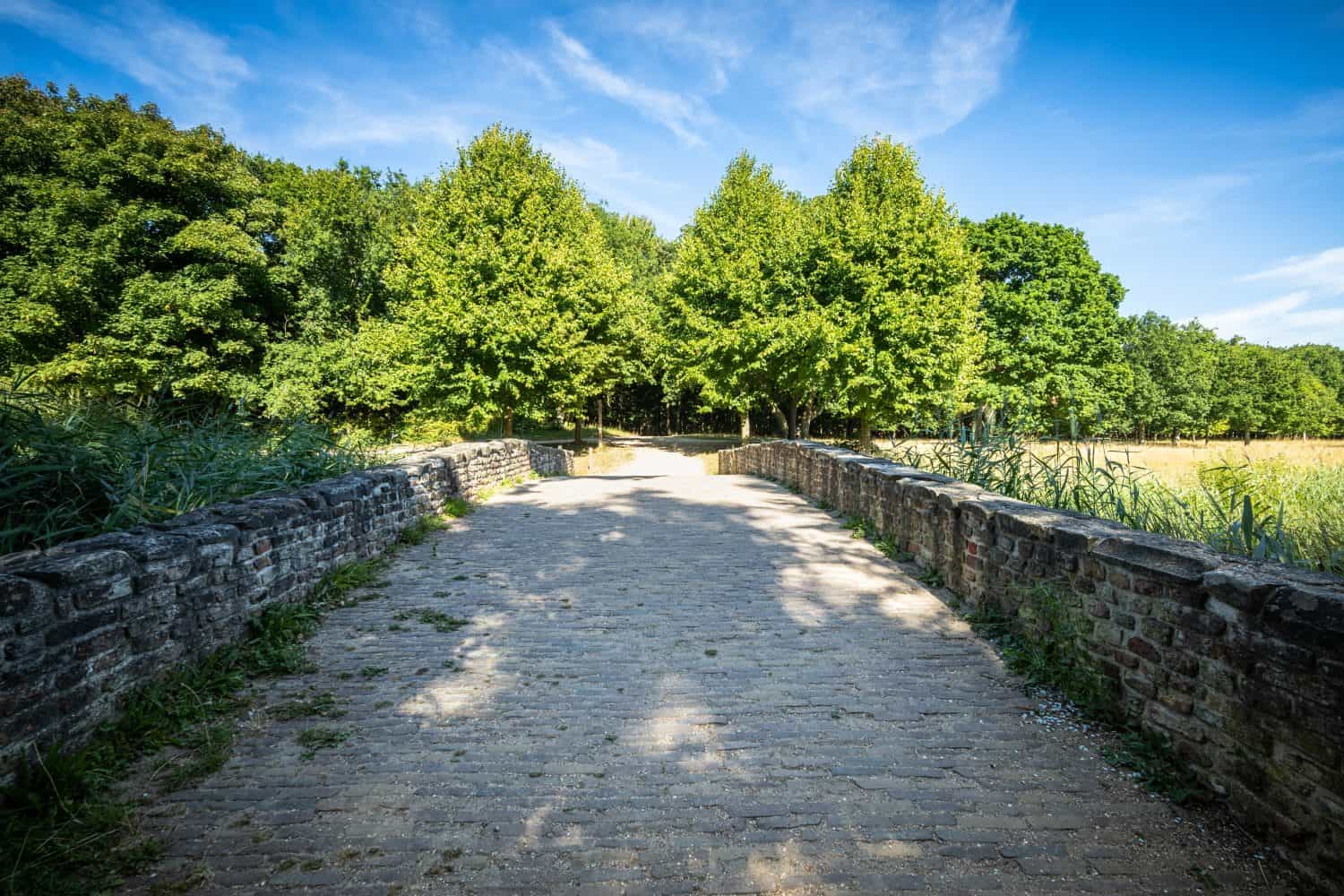 Old roman folly bridge in english landscape garden in park of castle near domburg in the province of Zeeland, the Netherlands