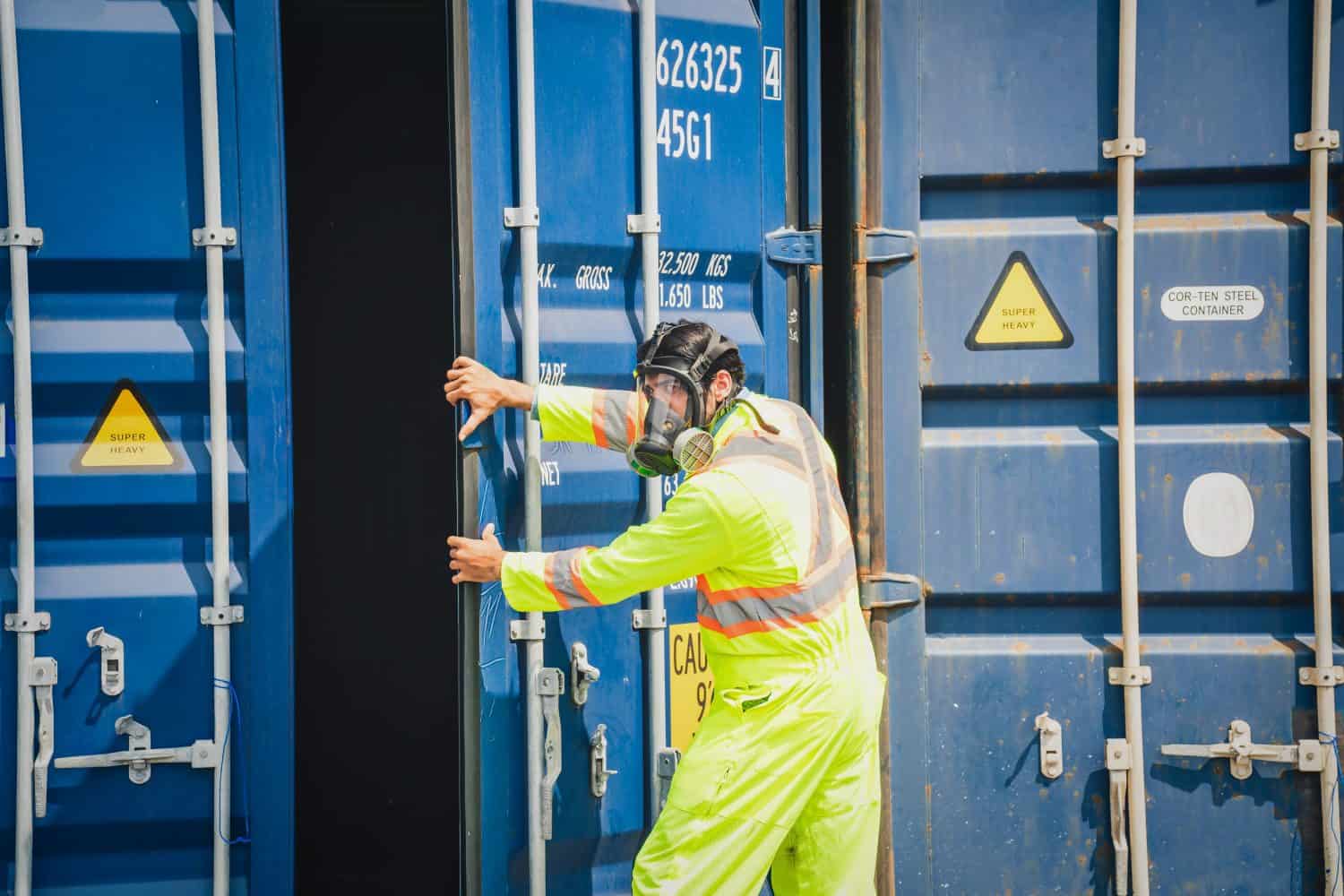 Engineer wear PPE checking inside container as Chemical spill in the container shipping industry