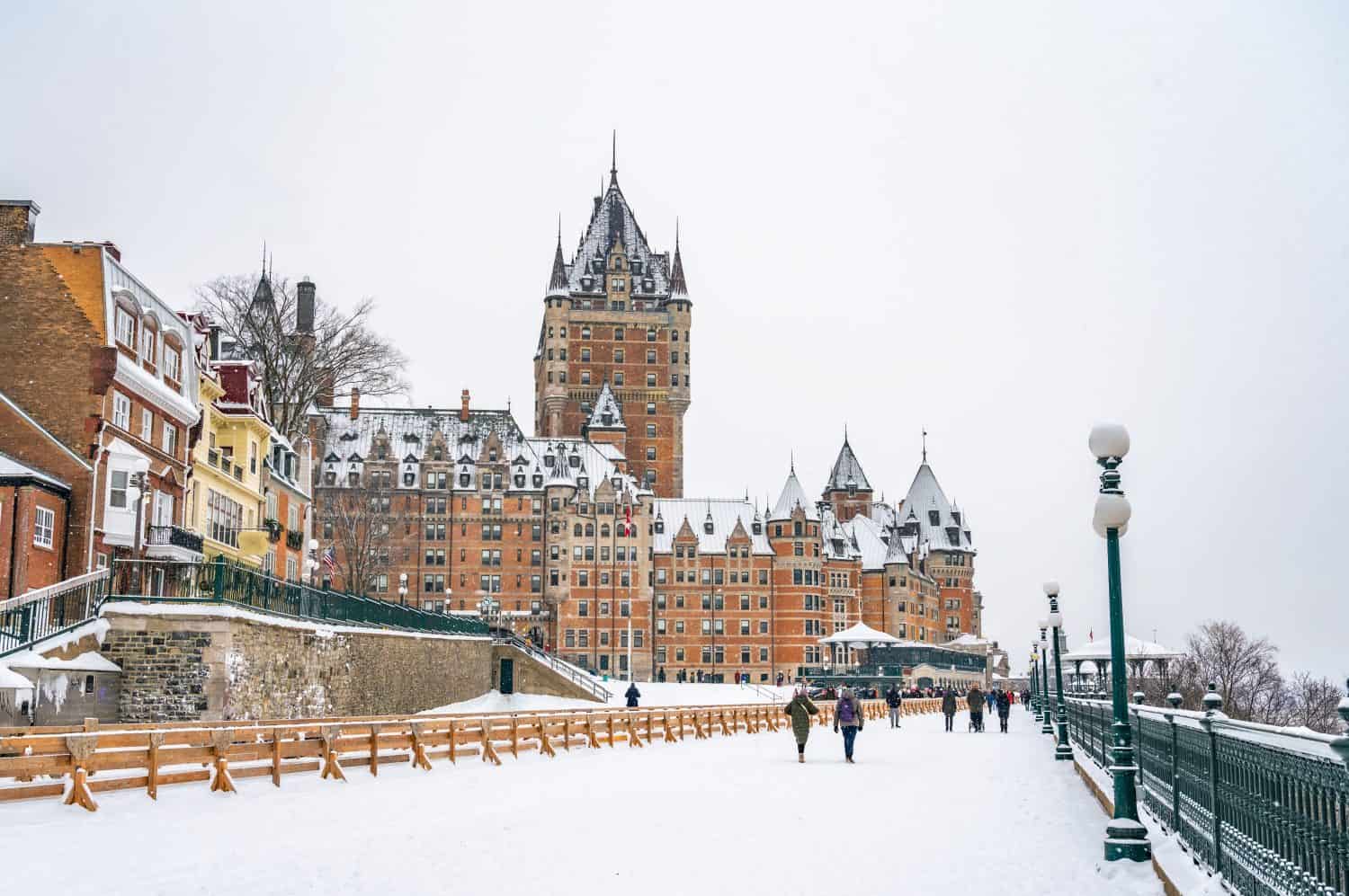 Dufferin Terrace, a long wooden sidewalk next to the historic Fairmont Chateau Frontenac hotel, giant tobogganing run in the winter on a snowy day, Quebec City, Canada. Photo taken in December 2022.