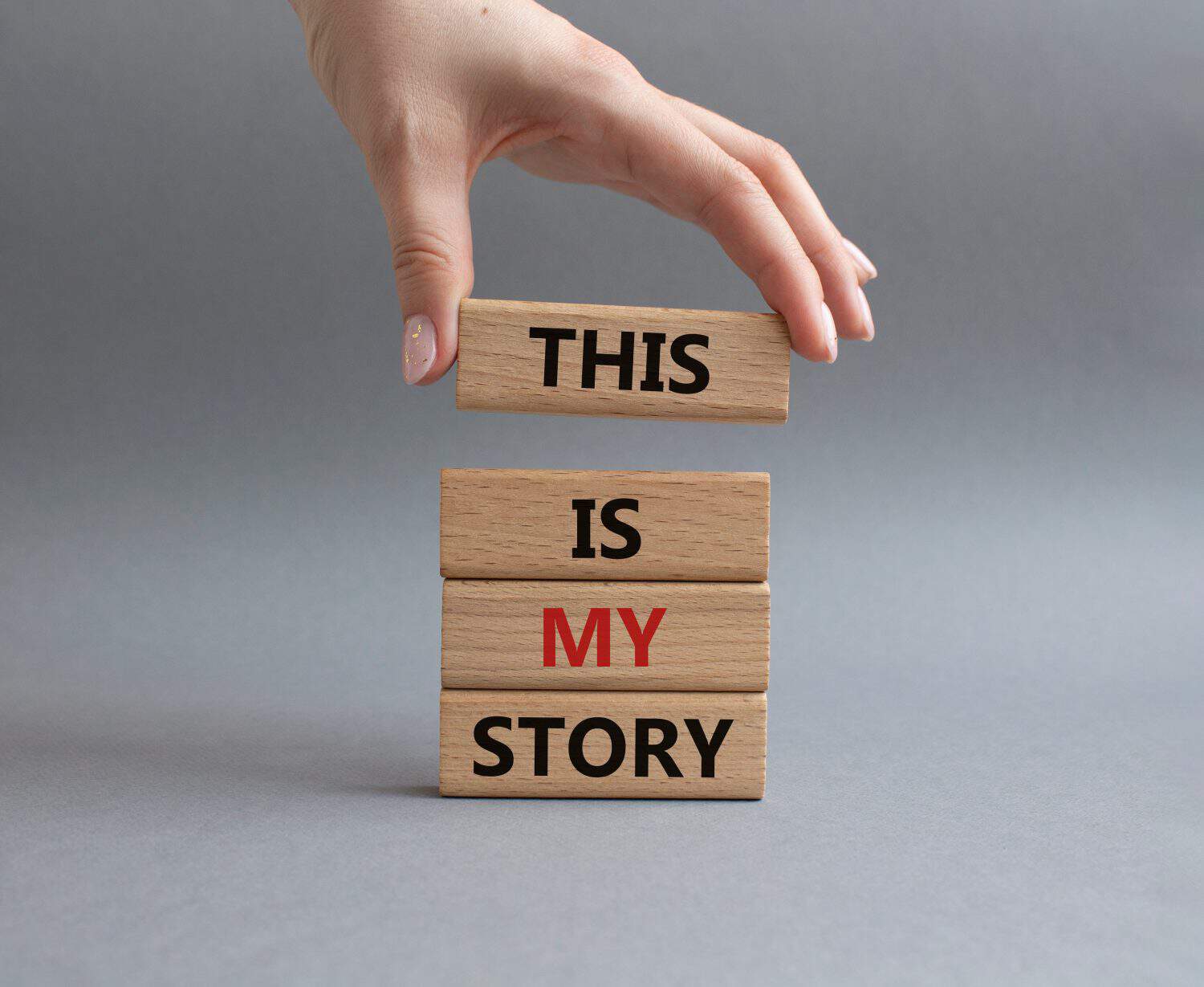 This is my Story symbol. Wooden blocks with words This is my Story. Businessman hand. Beautiful grey background. Business and This is my Story concept. Copy space.