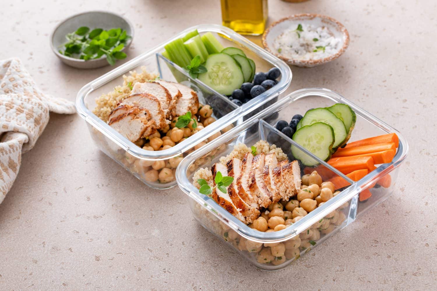 Meal prep containers with healthy high protein food prepped, cooked quinoa, chickpeas and eggs