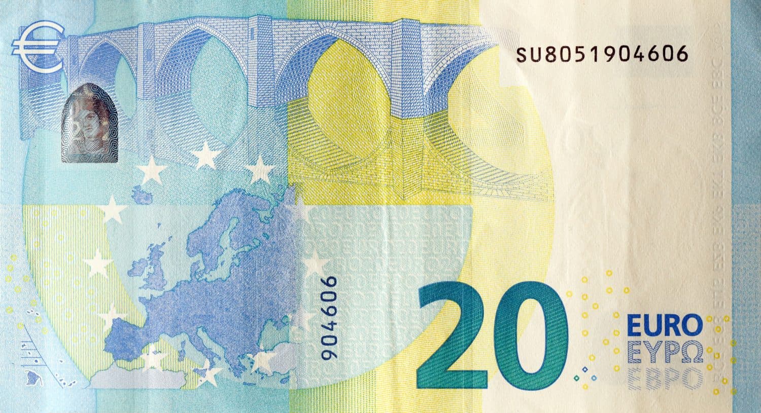 Fragment of one twenty euro money bill. Details of European union currency banknote of 20 euro close up