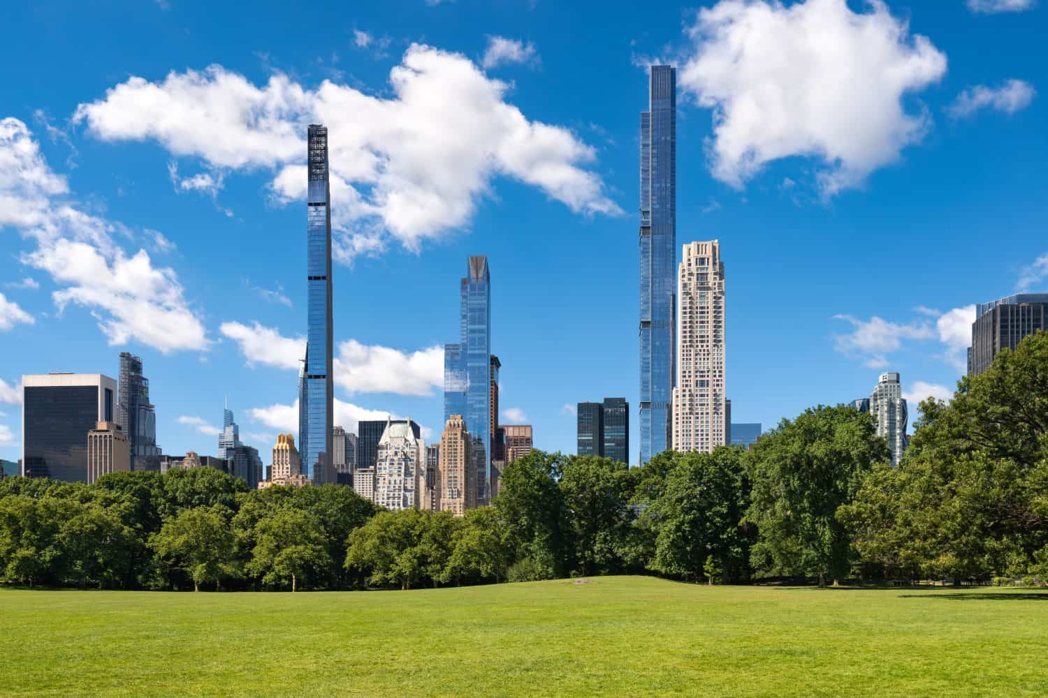 Central Park in summer with Billionaires' Row supertall skyscrapers from Sheep Meadow. Midtown Manhattan, New York City