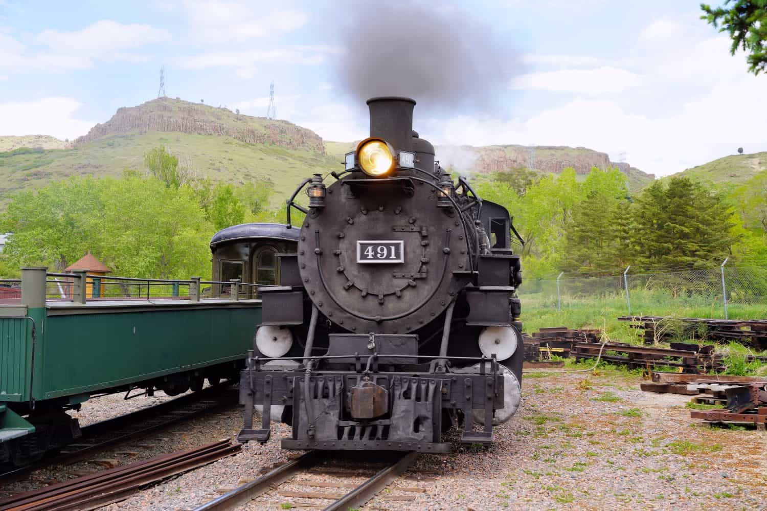 A Front View of Steam Locomotive 491 Steaming in a Train Yard