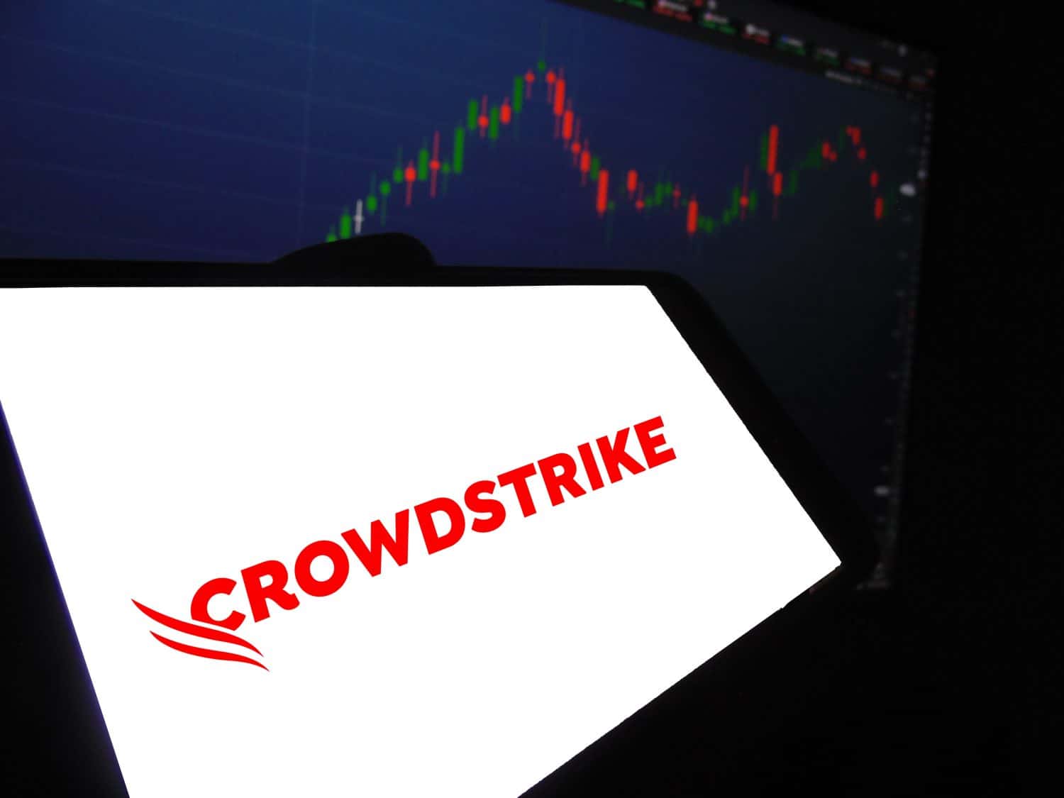 Recife, Brazil - July 25, 2024: Logo of CrowdStrike. CrowdStrike cybersecurity (CRWD) on smartphone screen with stock graph in the background USA company