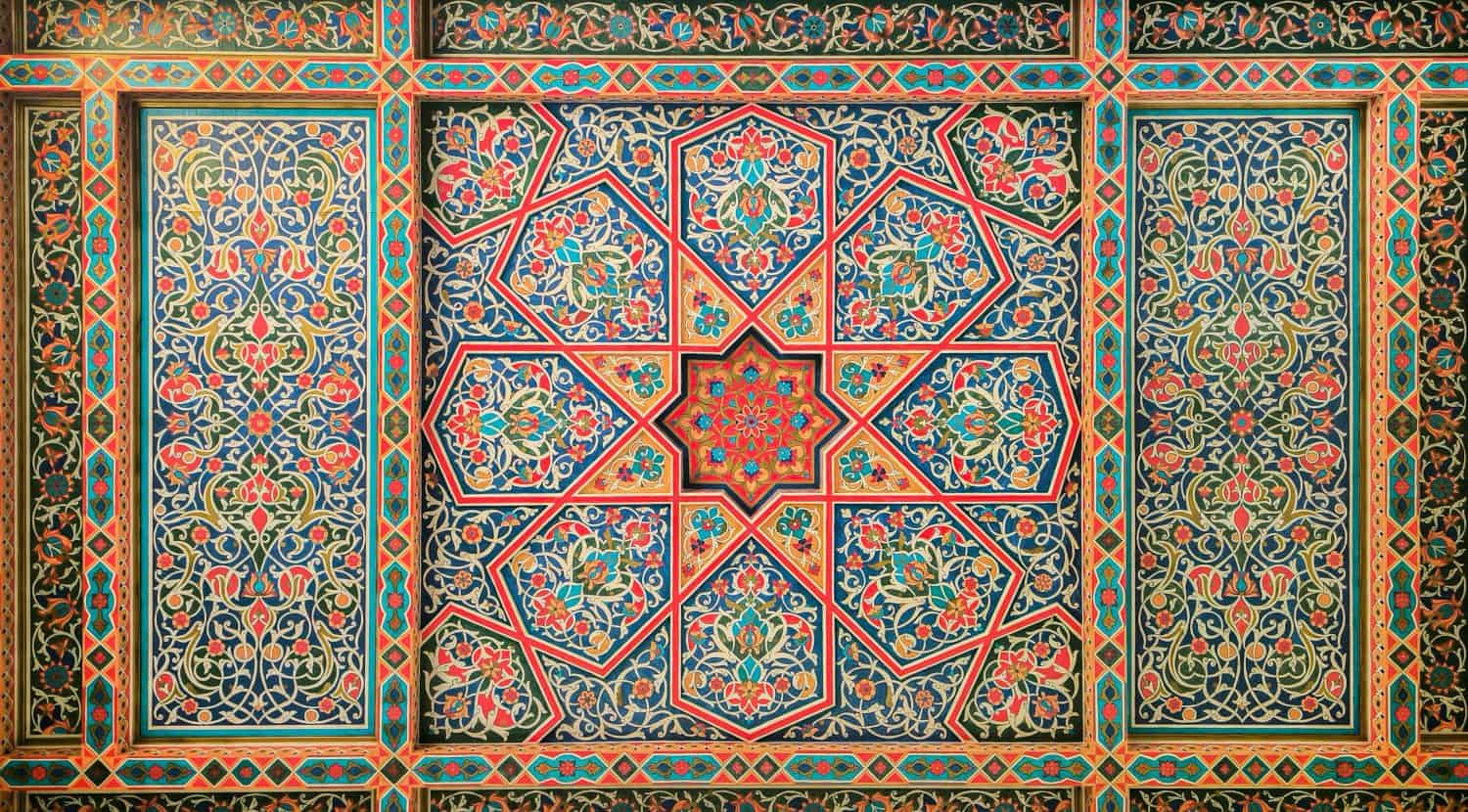 Wooden ceiling, national ornaments from Uzbekistan, mosaic red, green and orange asian background