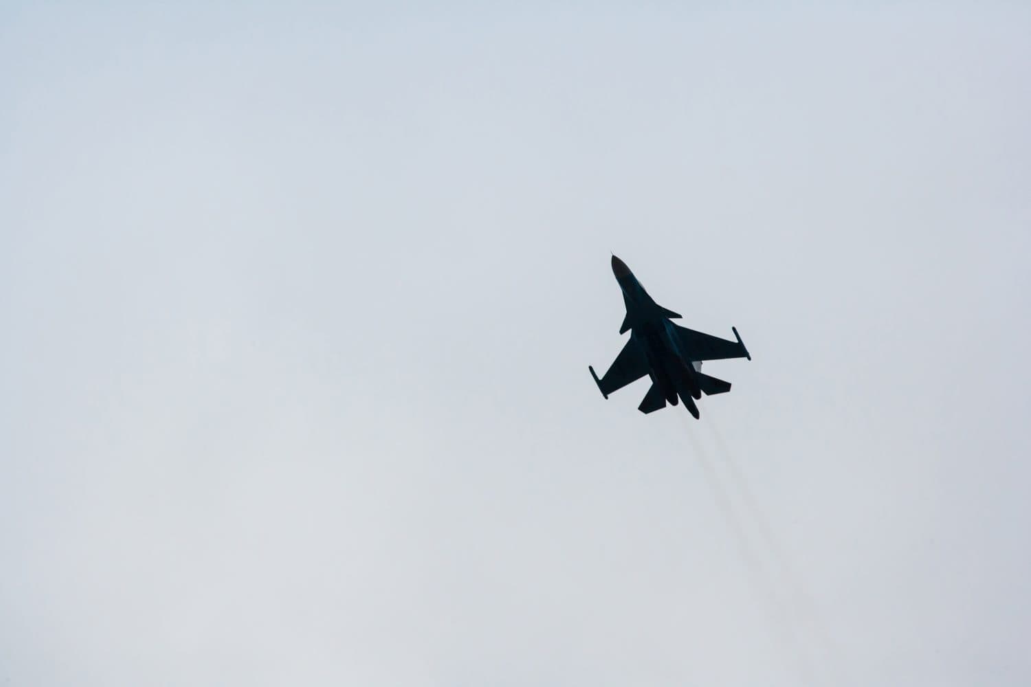 Silhouette of russian multi-purpose fighter-bomber Su-34 in the sky