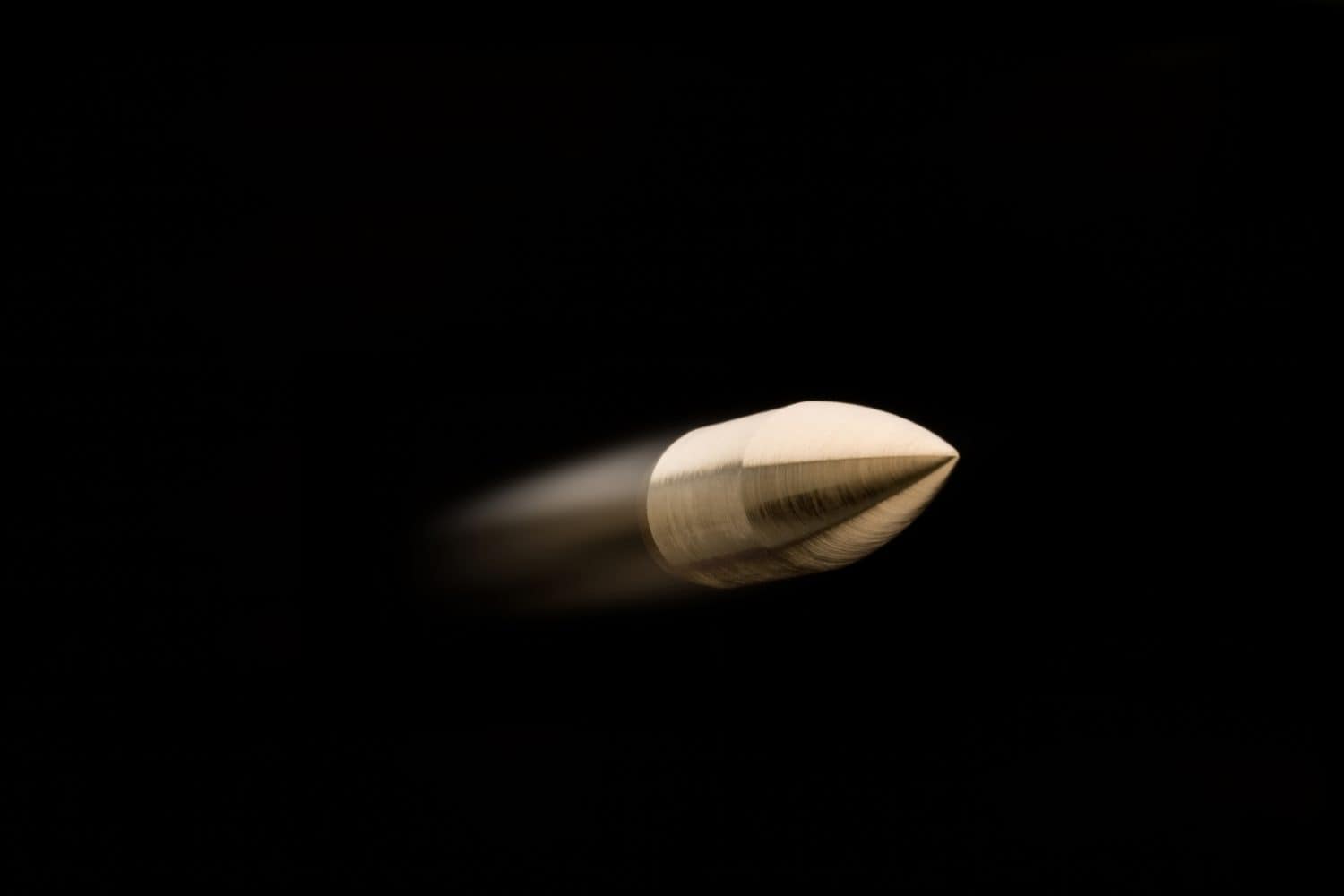 Flying bullet isolated on black background