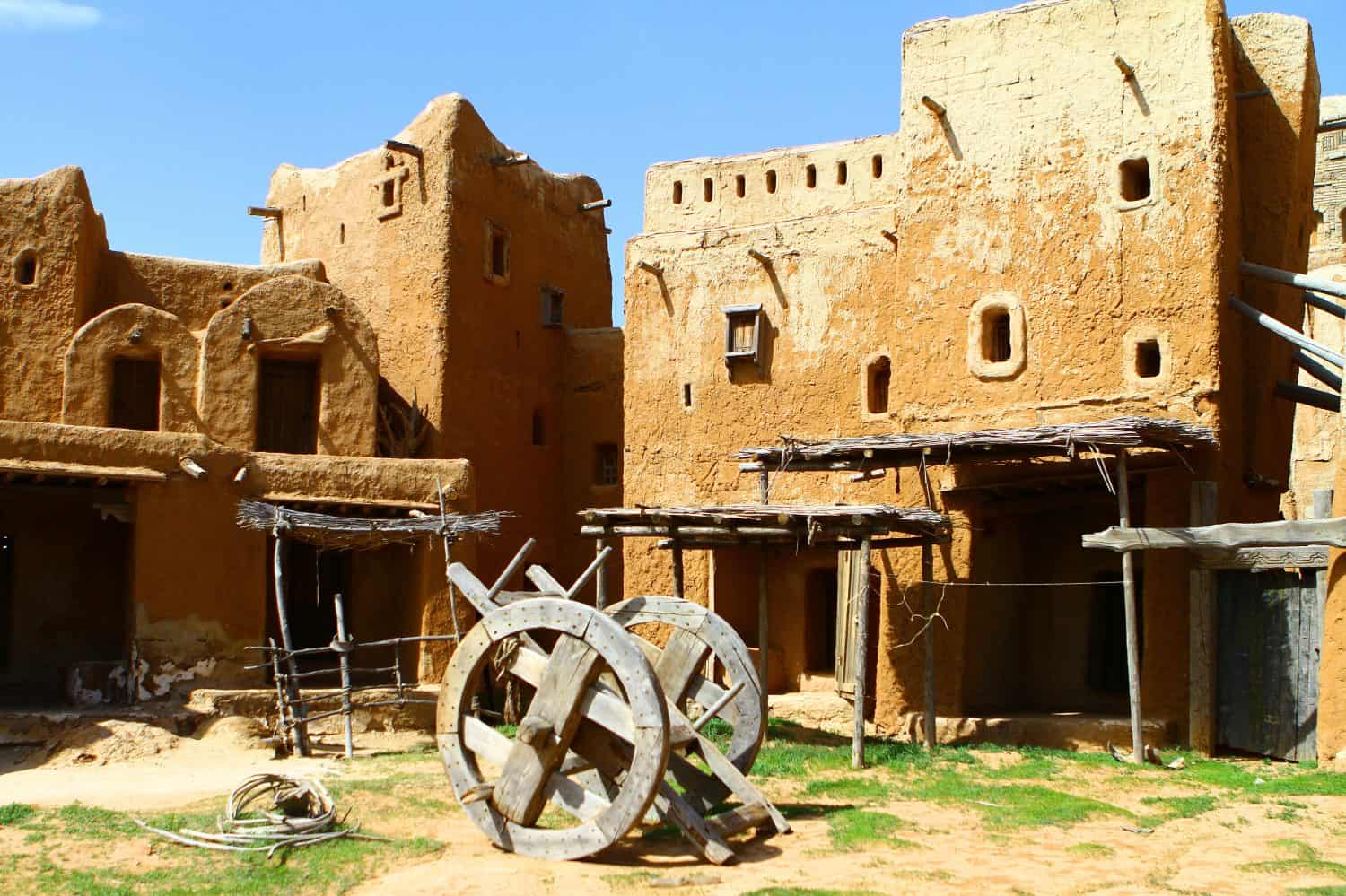 Reconstruction of the clay buildings and old wheeled cart in the ancient Tatar-Mongols capital of Sarai Batu