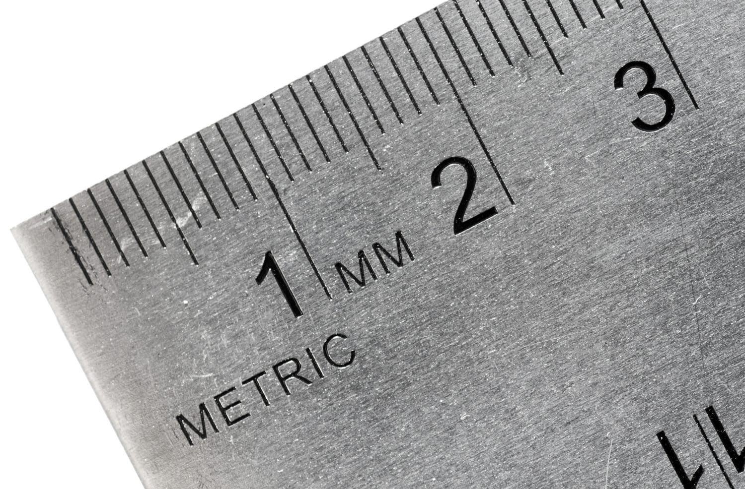 metric system Macro shot of an industrial stainless steel ruler, metric side.