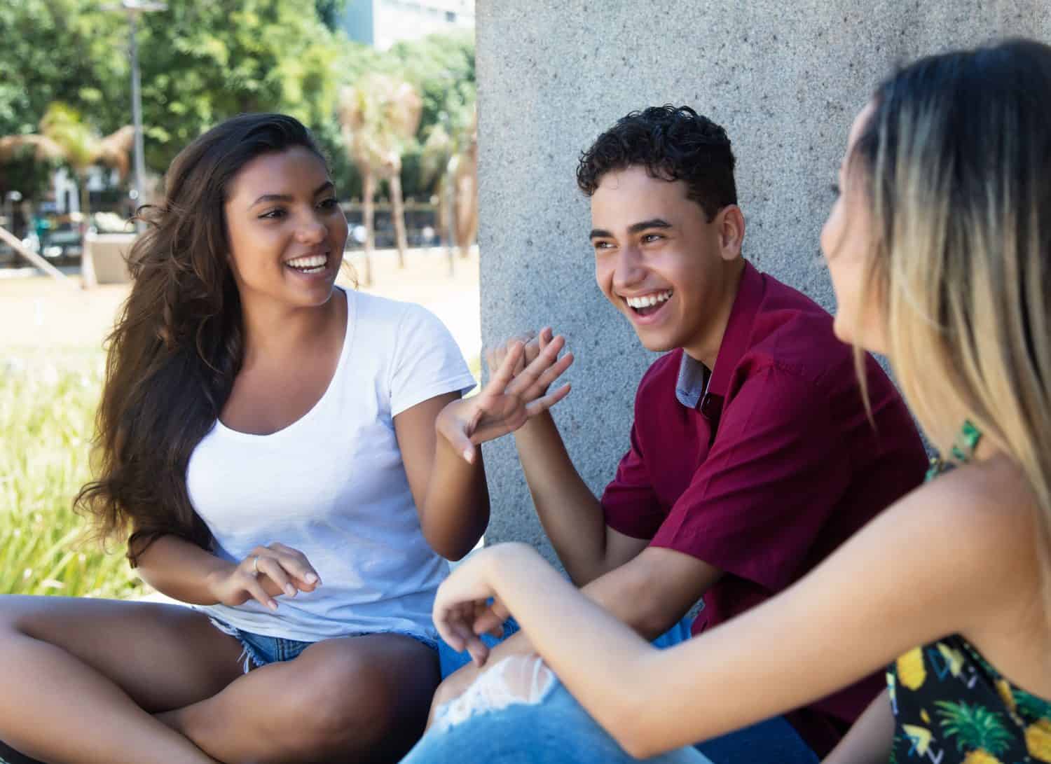 Latin woman talking with caucasian friends