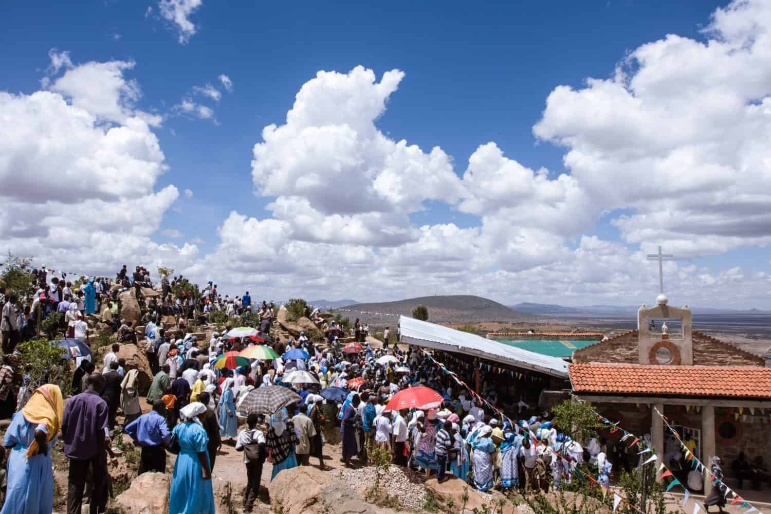 A group of African-Christian people celebrating a mass prayer for Jesus.