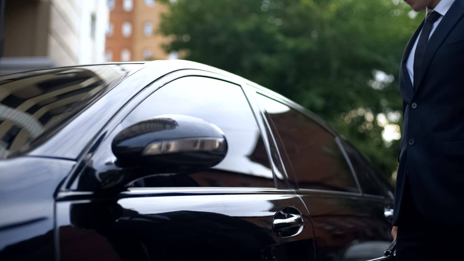 Man standing near expensive armored car, security system of automobile, safety