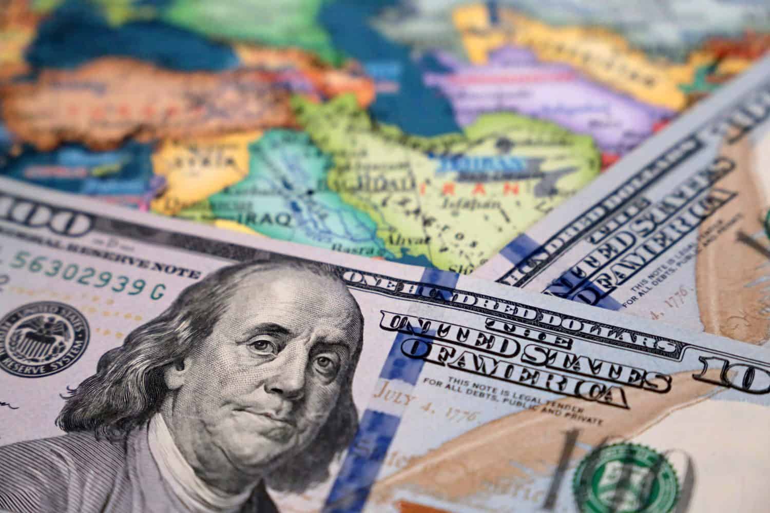 US dollars on the map of Iran and Iraq. Conflict between Washington and Tehran, trading in middle East, oil industry