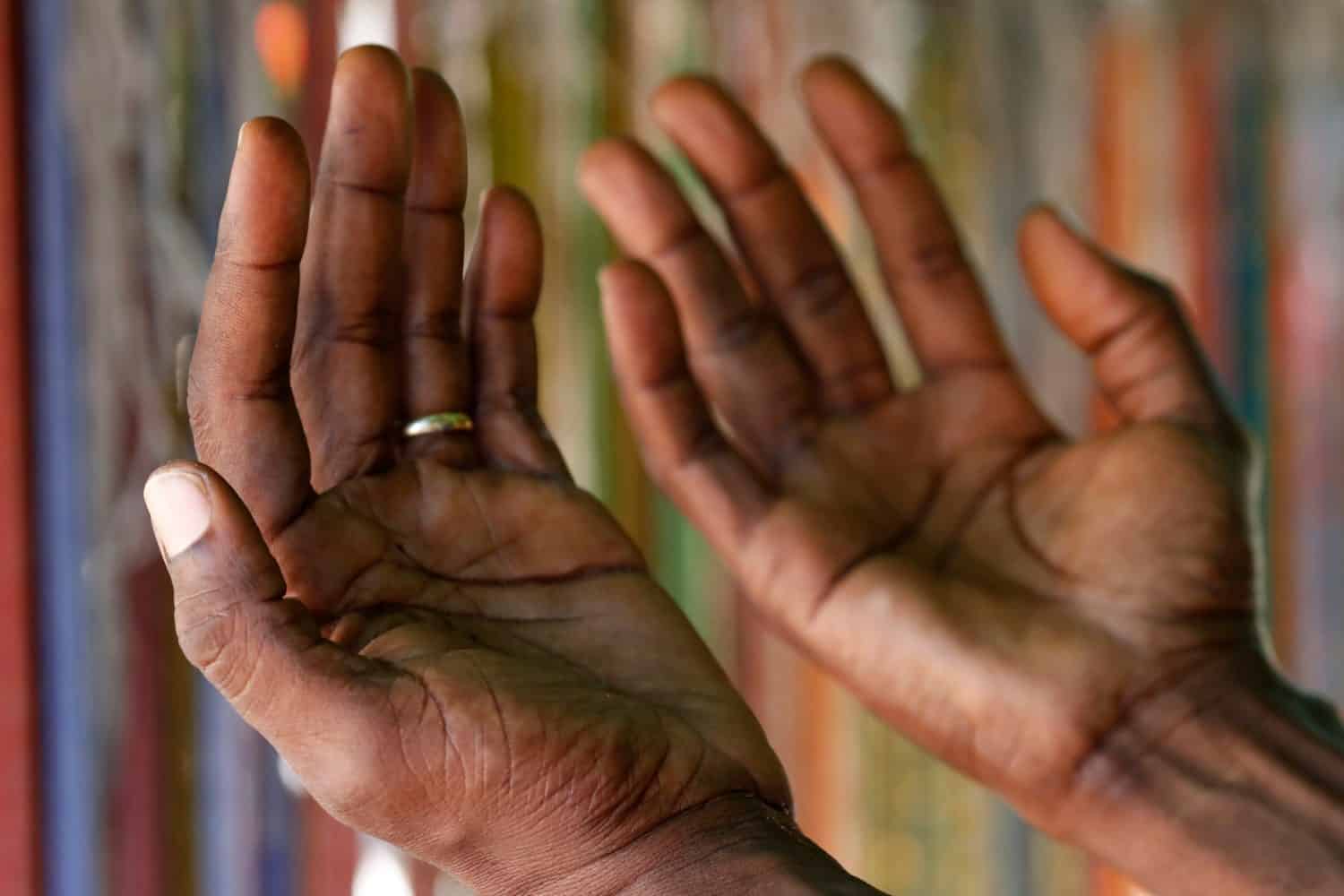 Christian man praying god. Close-up on hands. Lome. Togo.